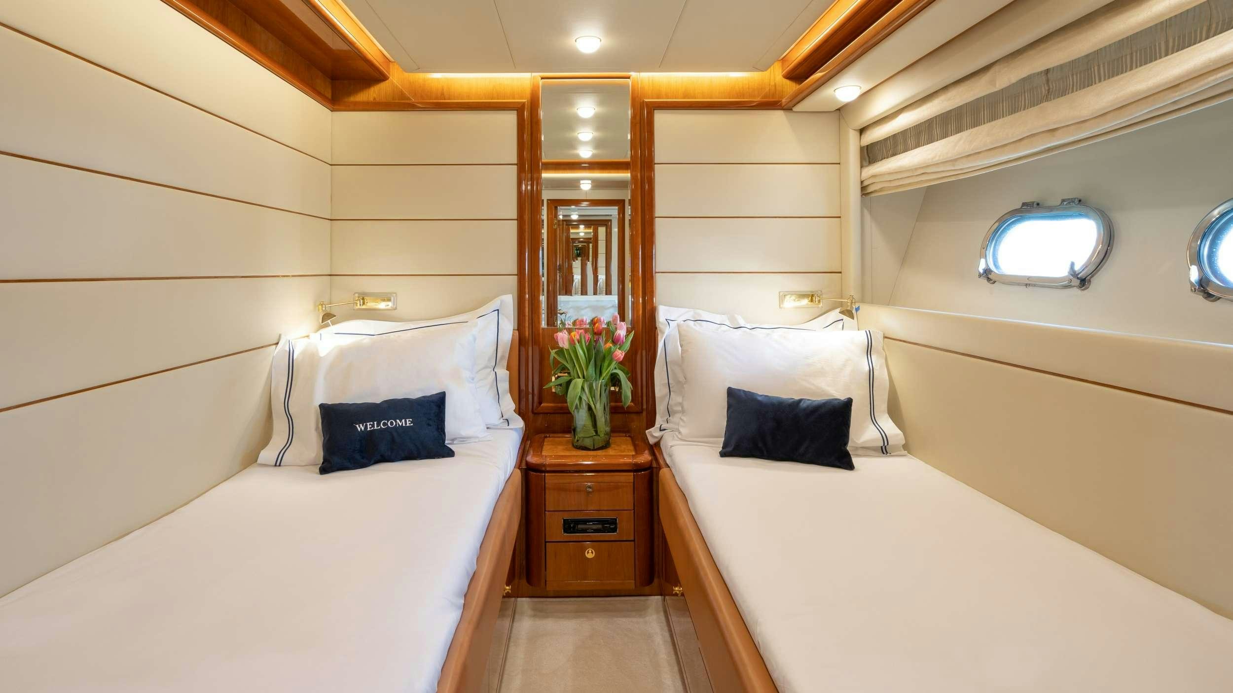 a room with a bed and a mirror aboard ESTIA YI Yacht for Charter