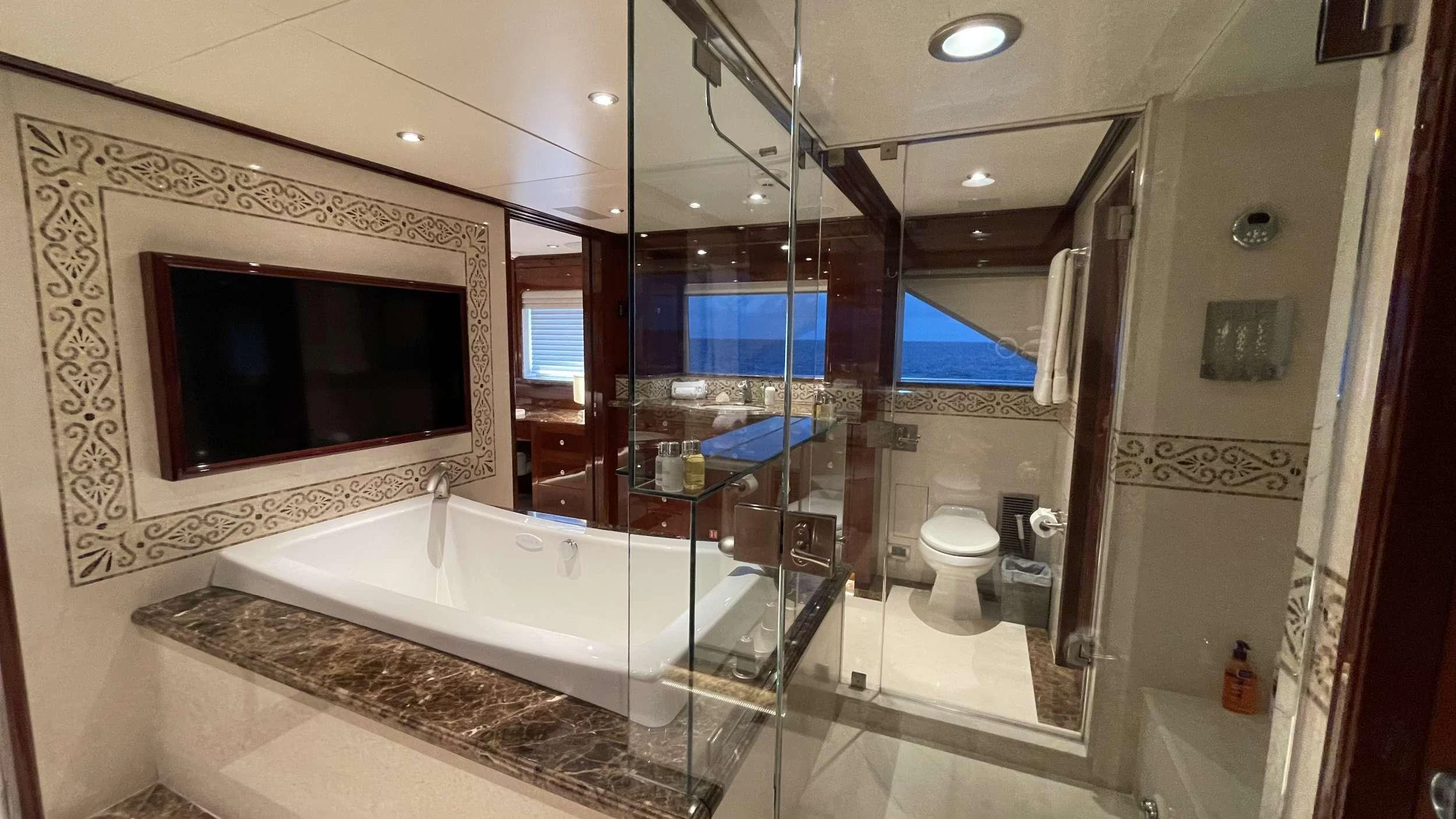 a bathroom with a glass shower aboard KASHMIR Yacht for Charter
