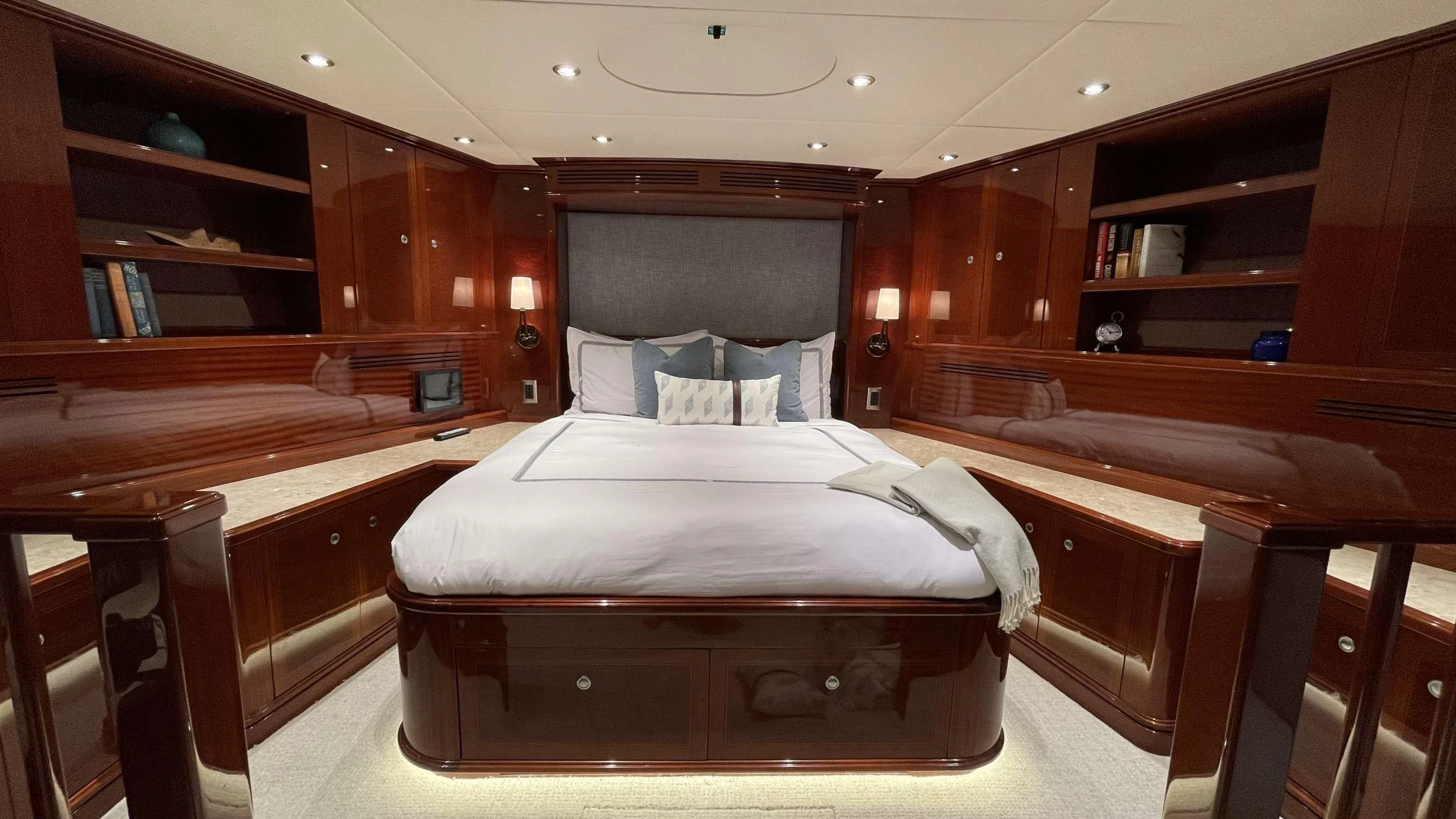 a room with a bed and desk aboard KASHMIR Yacht for Charter