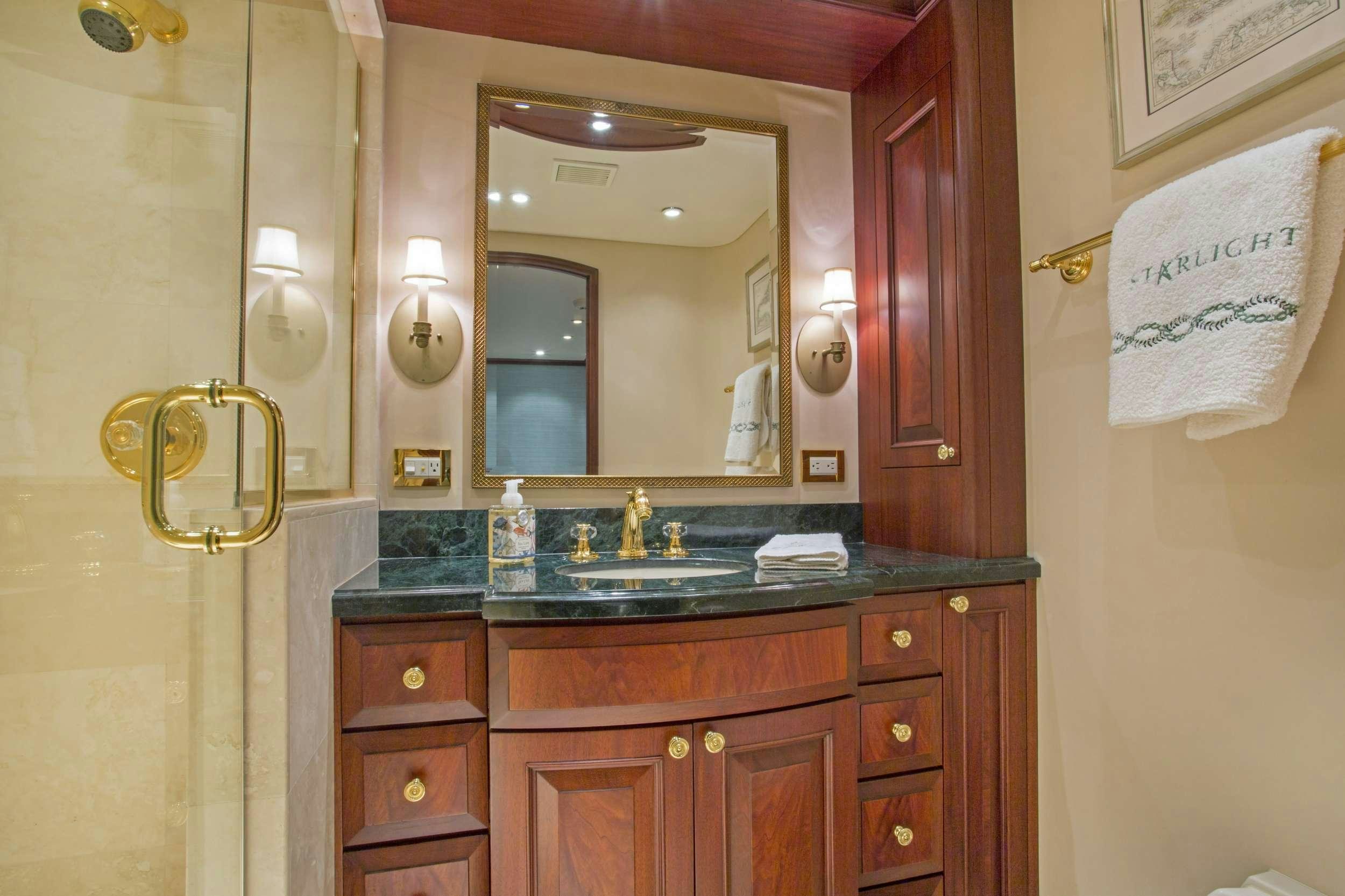 a bathroom with a sink and a mirror aboard STARLIGHT Yacht for Charter