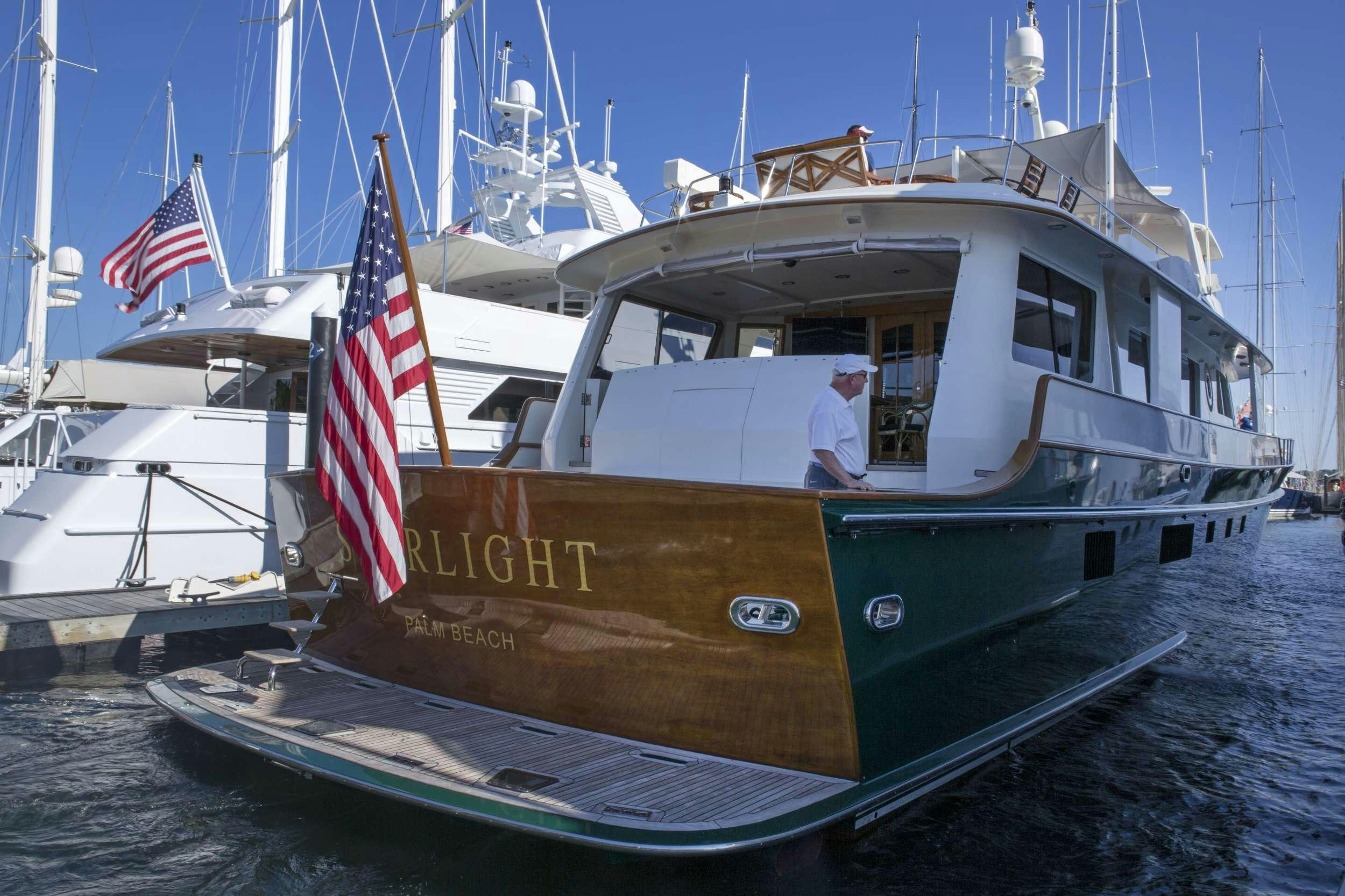 a boat with a flag on the front aboard STARLIGHT Yacht for Charter