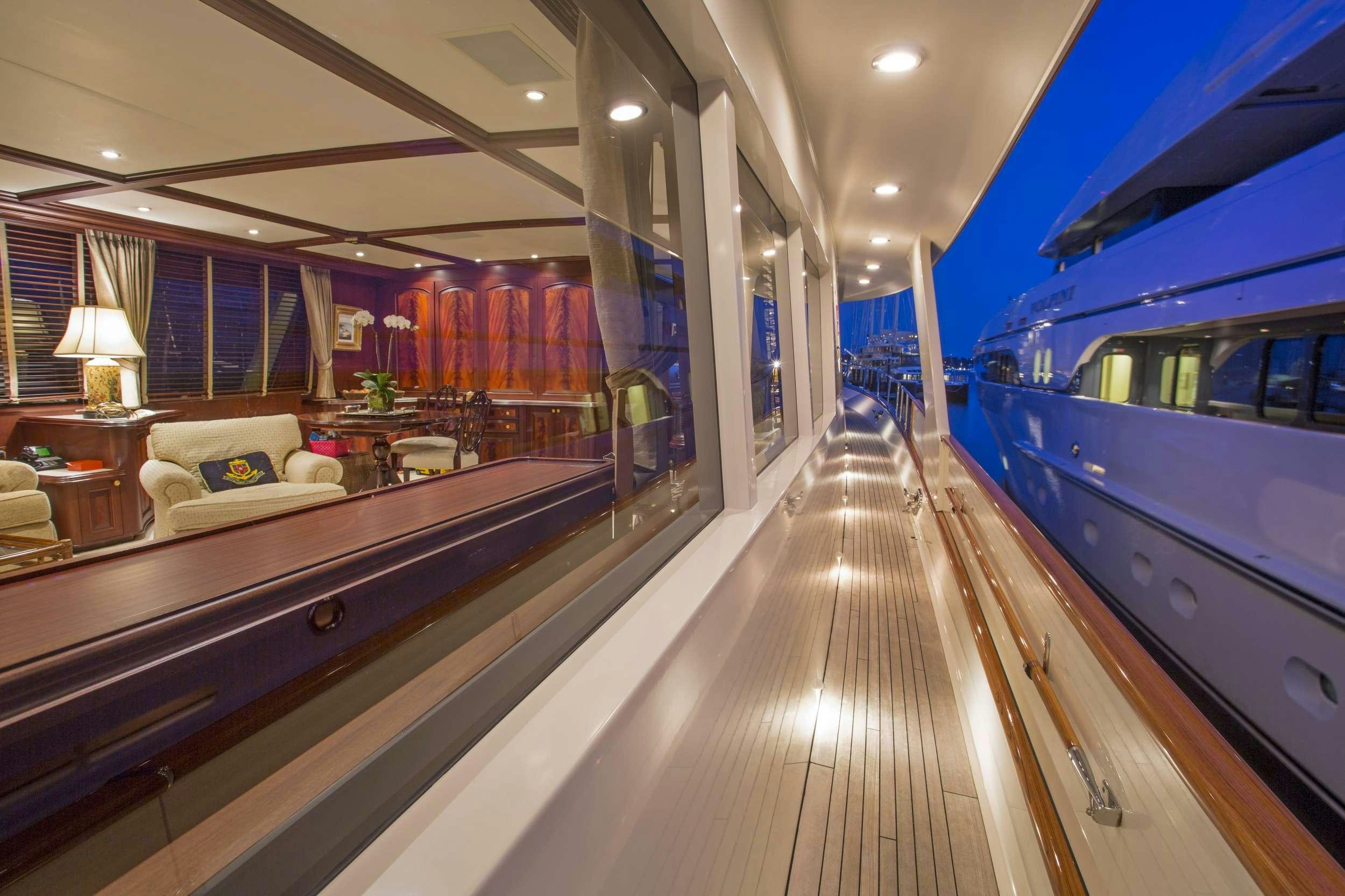 a long hallway with a bed and a couch aboard STARLIGHT Yacht for Charter