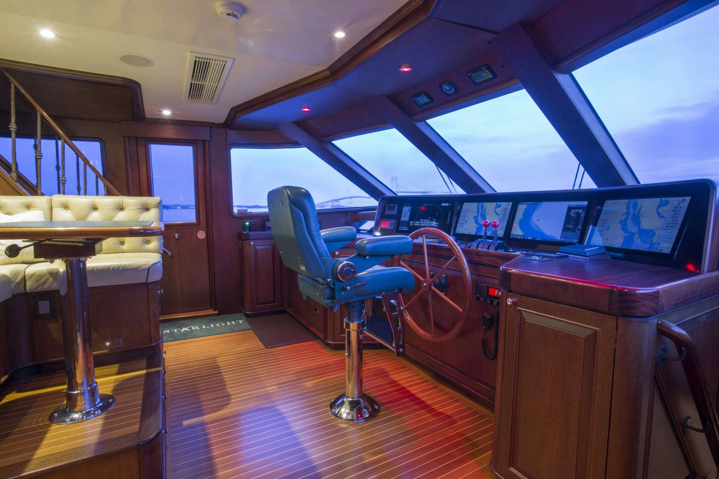 a room with a table and chairs aboard STARLIGHT Yacht for Charter
