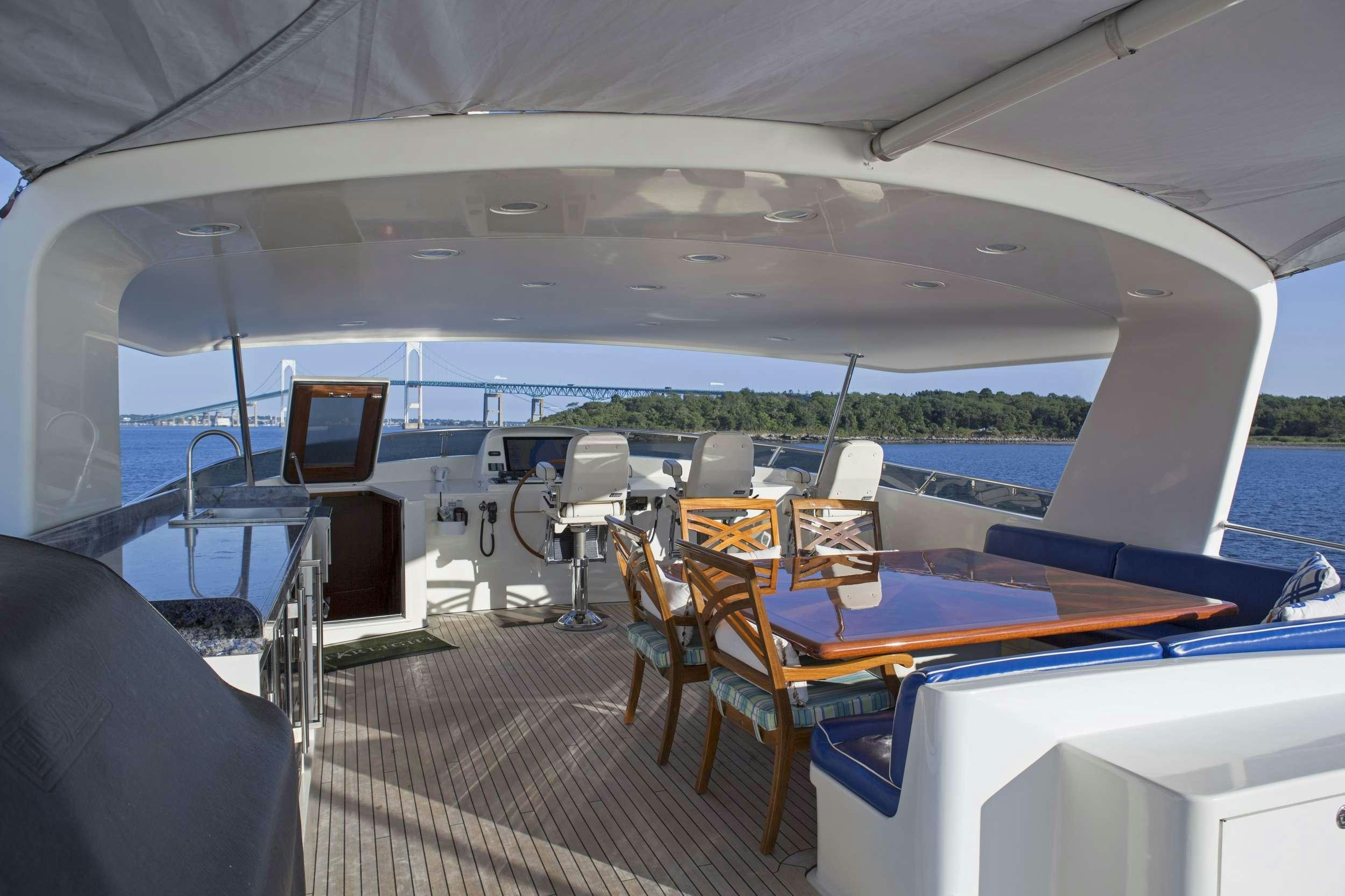 a boat with a deck and chairs aboard STARLIGHT Yacht for Charter