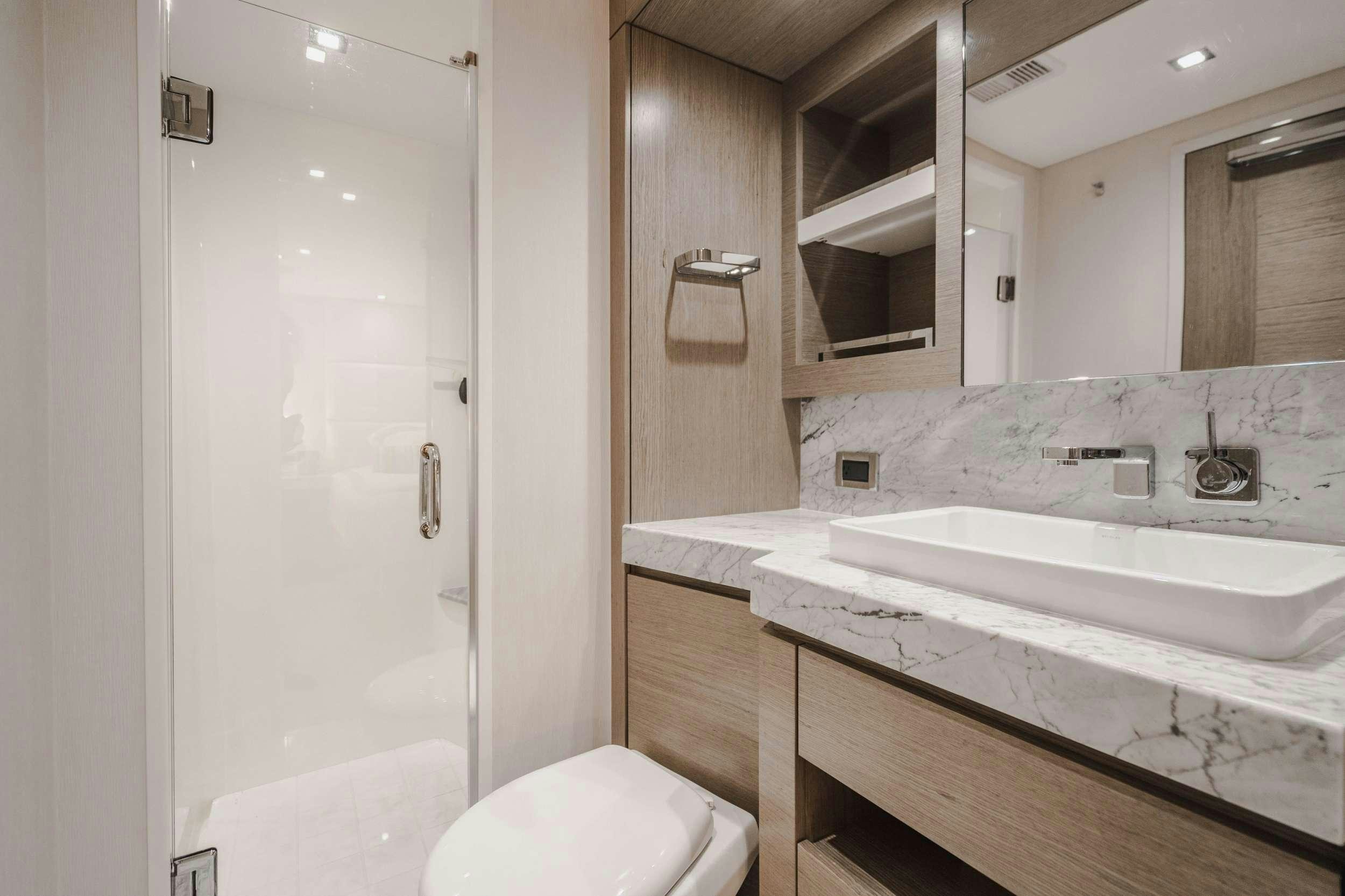 a bathroom with a sink and a toilet aboard BELLA SKY Yacht for Charter