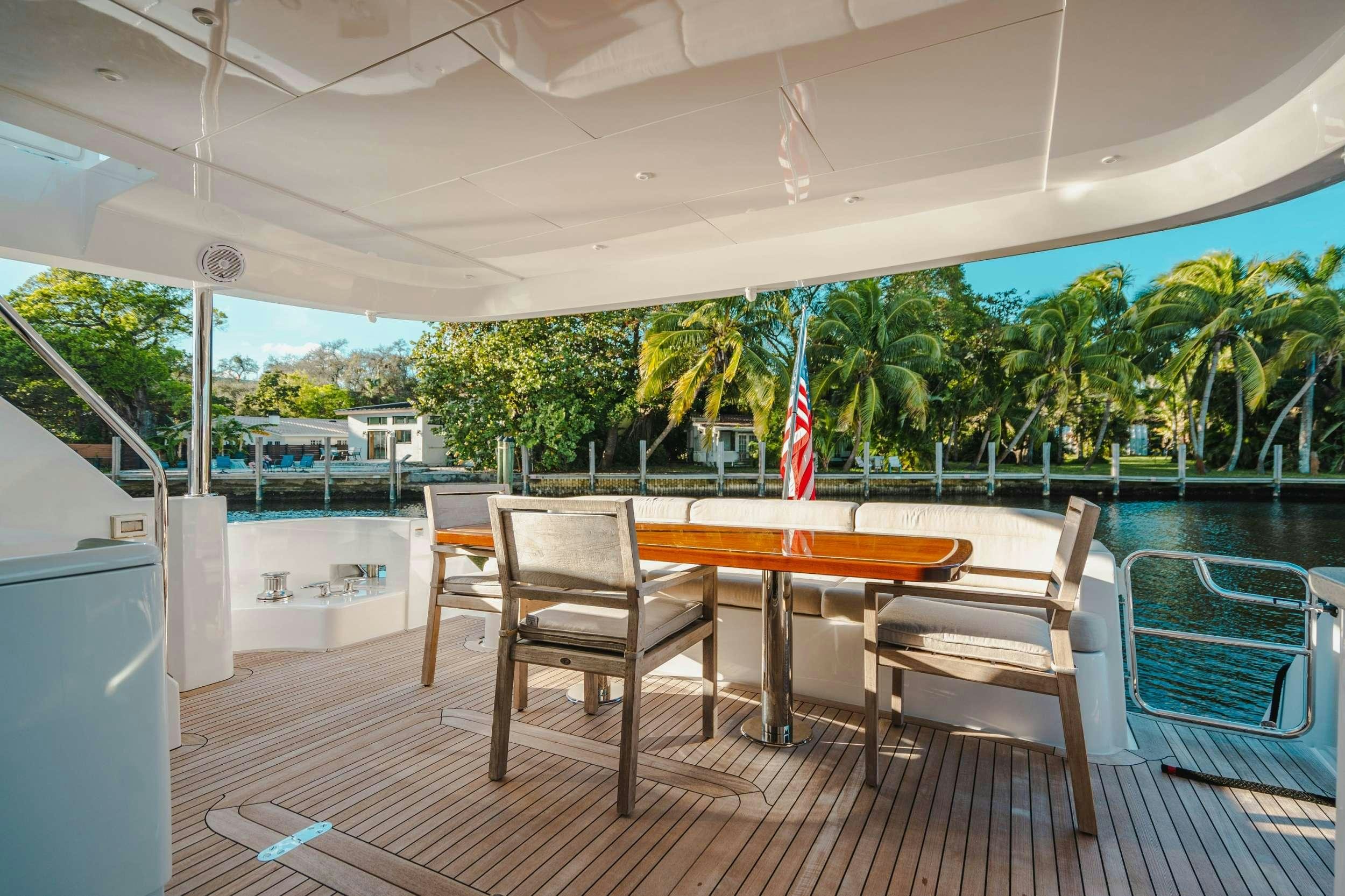 a table and chairs on a deck aboard BELLA SKY Yacht for Charter