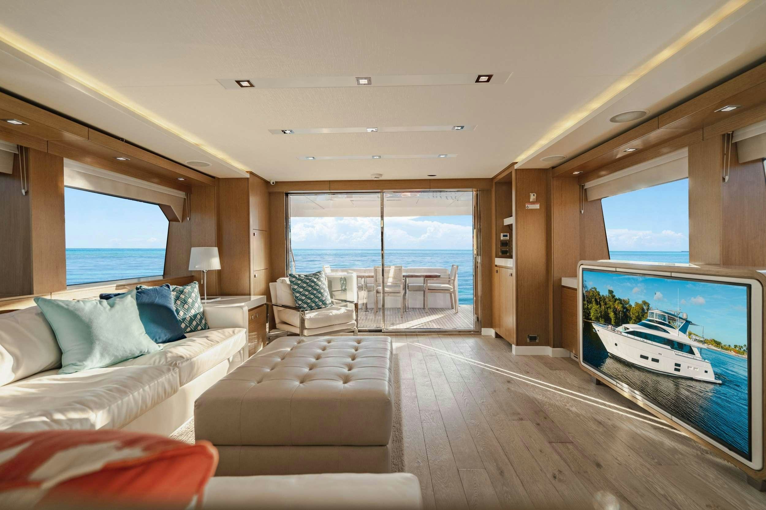 a living room with a large window aboard BELLA SKY Yacht for Charter