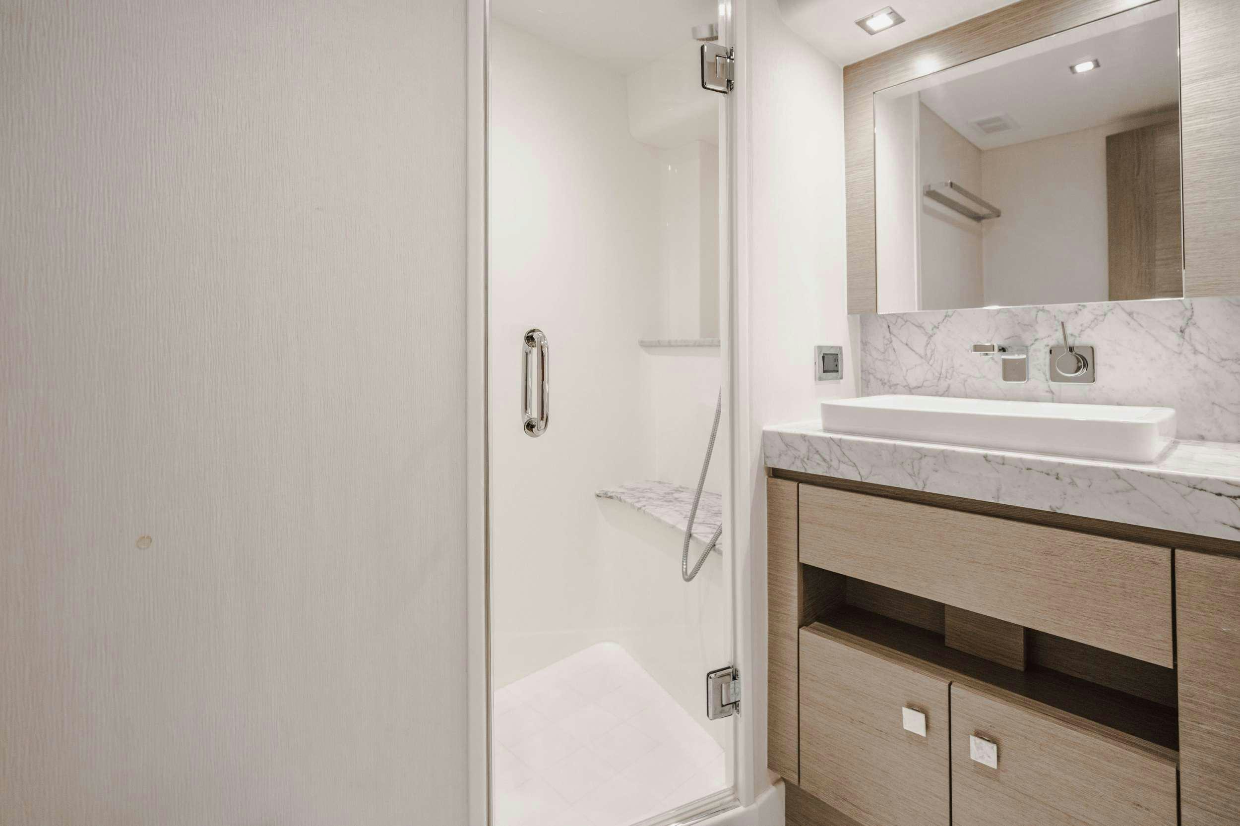 a bathroom with a sink and a mirror aboard BELLA SKY Yacht for Charter