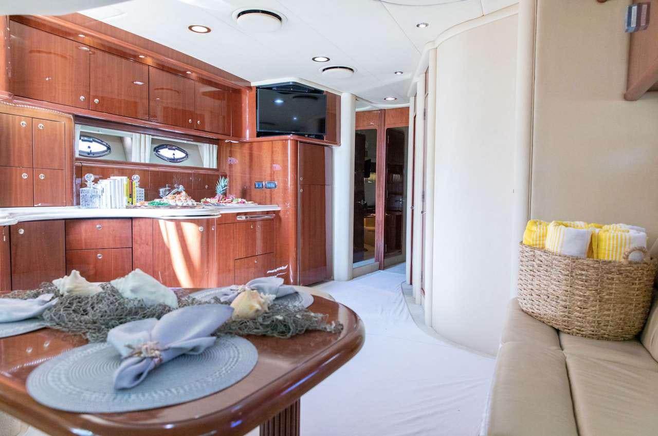 a room with a bed and a television aboard Low Profile Yacht for Charter