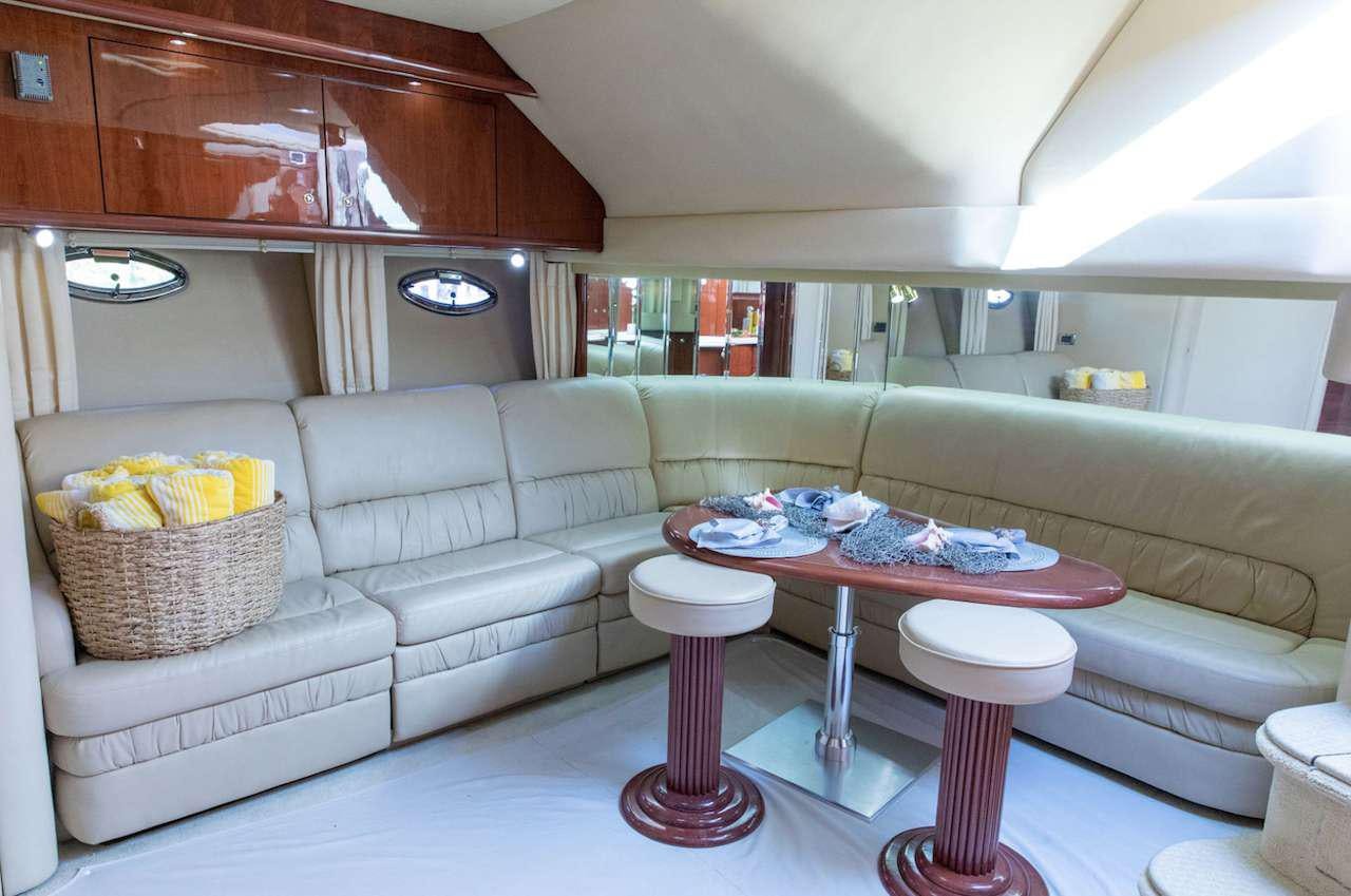 a living room with a couch and a table aboard Low Profile Yacht for Charter