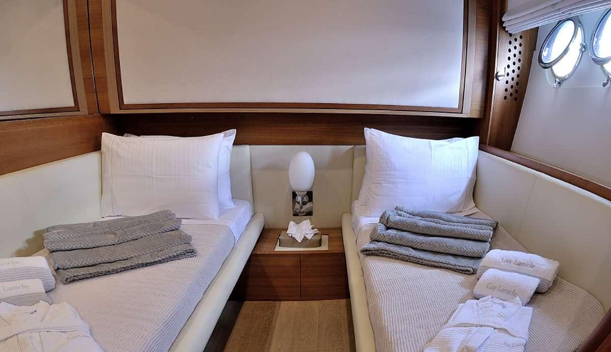 a couple of beds in a hotel room aboard FUNSEA Yacht for Charter