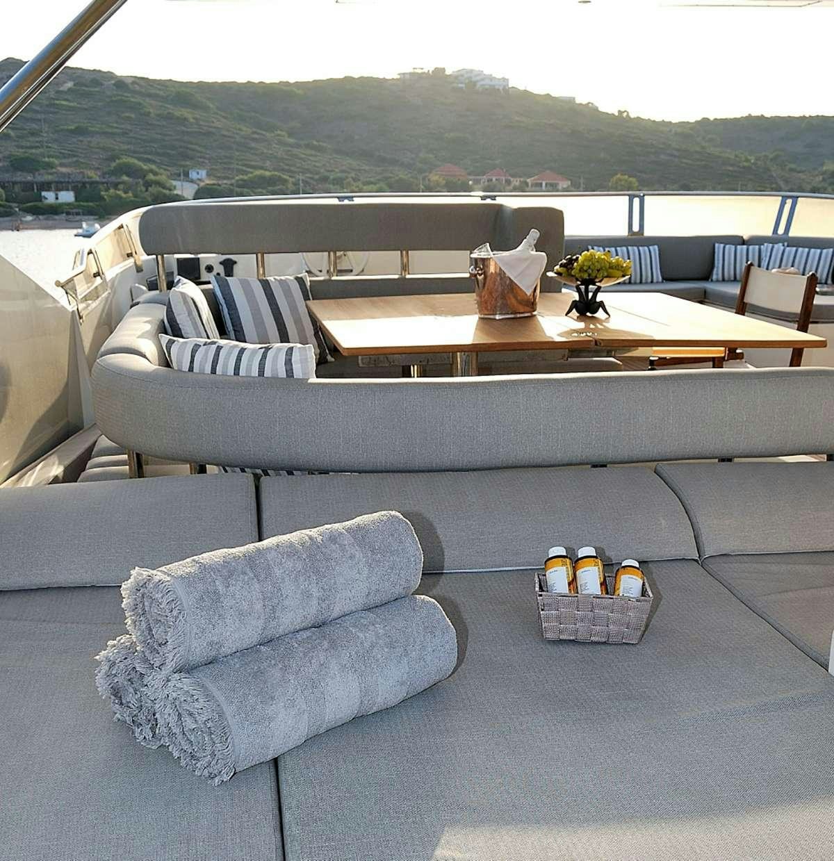 a couch with a table and chairs aboard FUNSEA Yacht for Charter