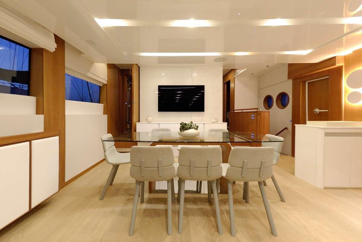 a large kitchen with a table and chairs aboard FUNSEA Yacht for Charter