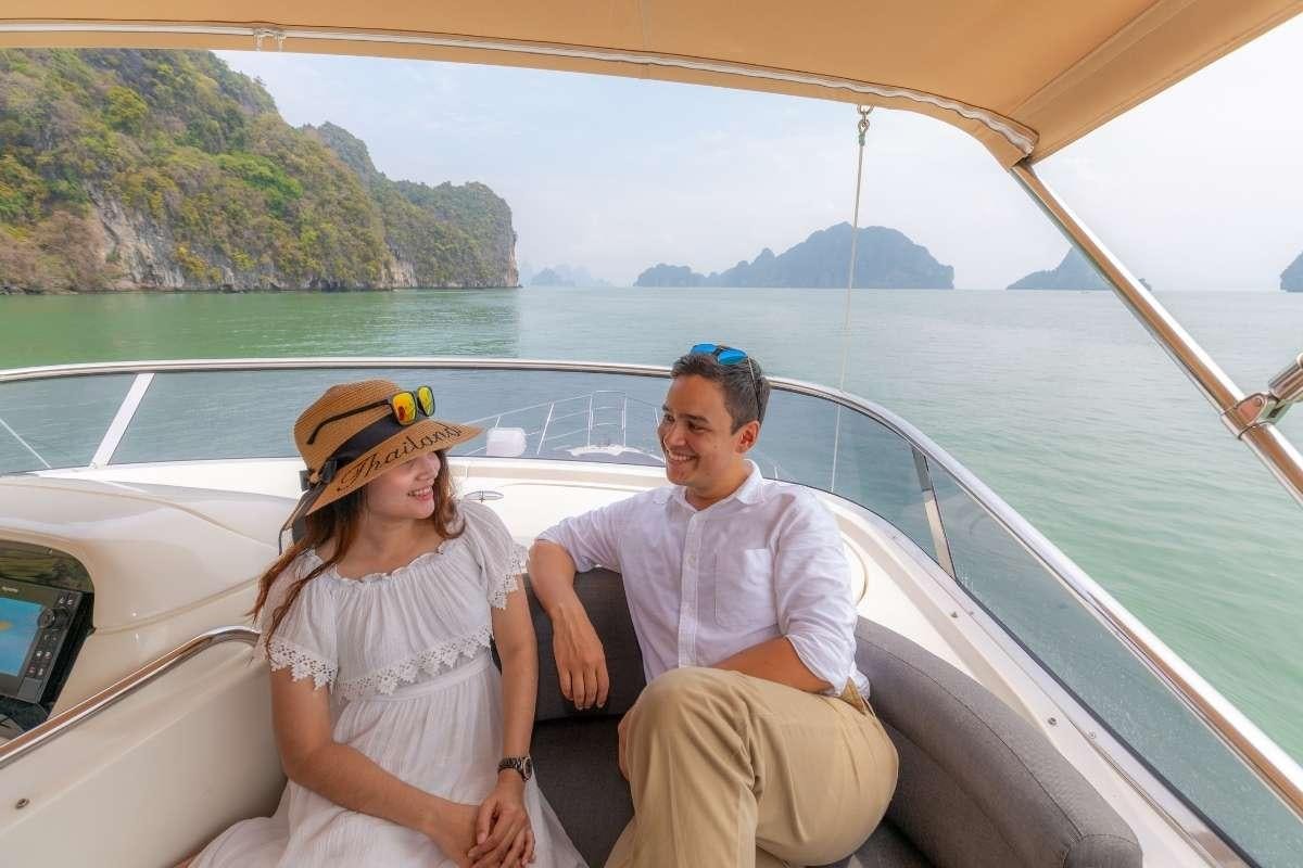 a man and woman sitting on a boat aboard 137 PILLARS SPIRIT Yacht for Charter