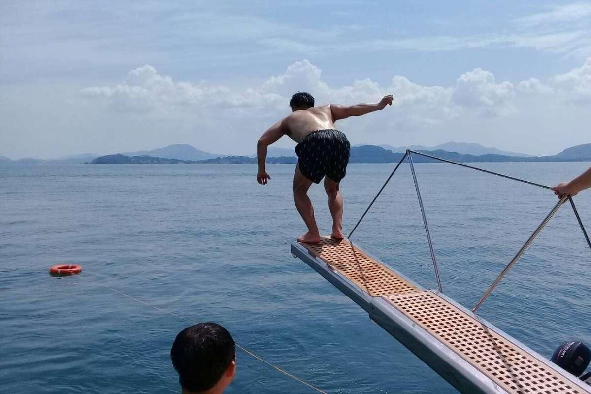 a man standing on a boat aboard 137 PILLARS SPIRIT Yacht for Charter
