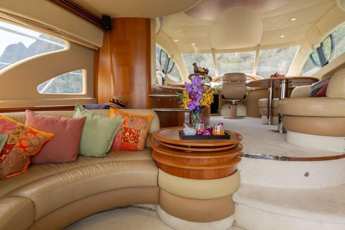 a living room with a large potted plant and a fireplace aboard 137 PILLARS SPIRIT Yacht for Charter