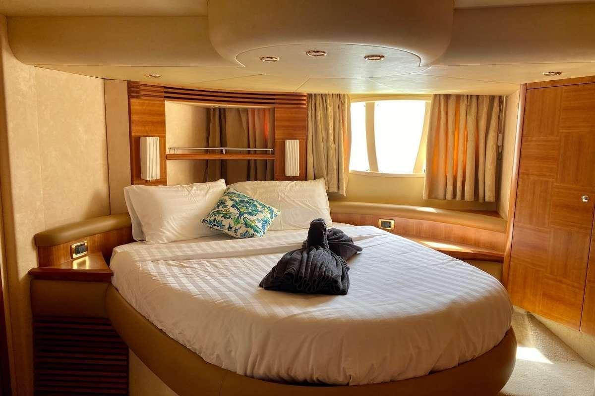 a bed with white sheets and pillows aboard 137 PILLARS SPIRIT Yacht for Charter