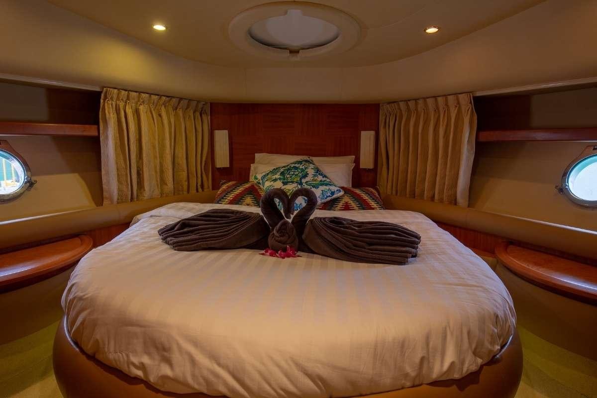 a bed with a couple of pillows on it aboard 137 PILLARS SPIRIT Yacht for Charter
