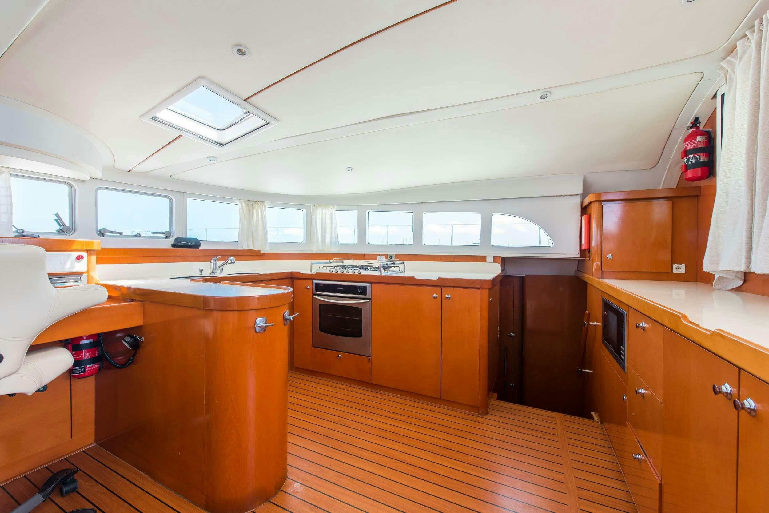 a kitchen with wooden cabinets aboard JOVA Yacht for Charter