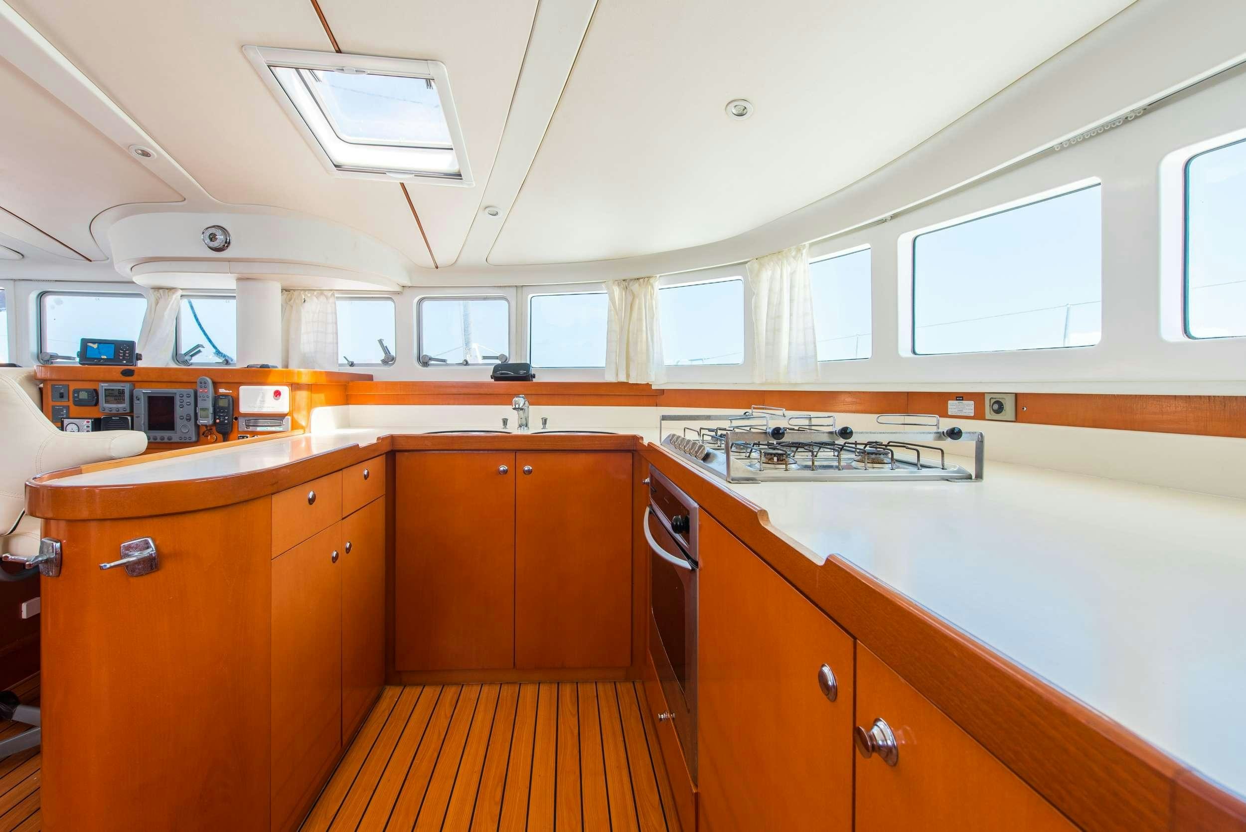 a kitchen with wooden cabinets aboard JOVA Yacht for Charter