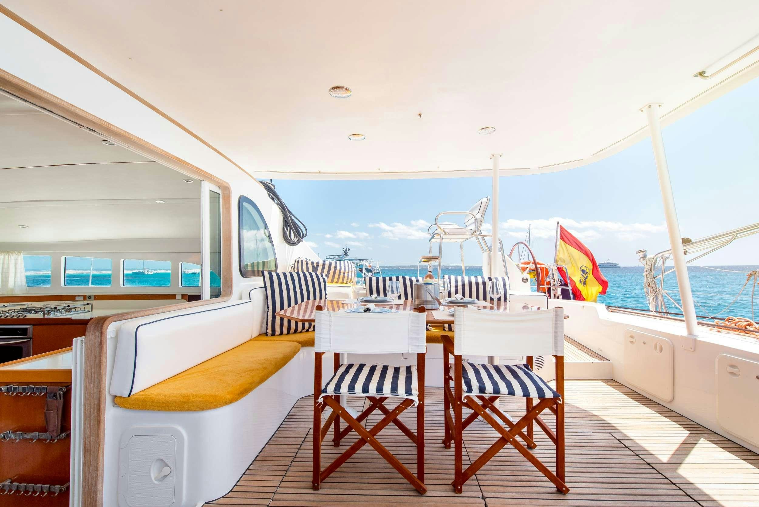 a boat with chairs and tables on a deck aboard JOVA Yacht for Charter