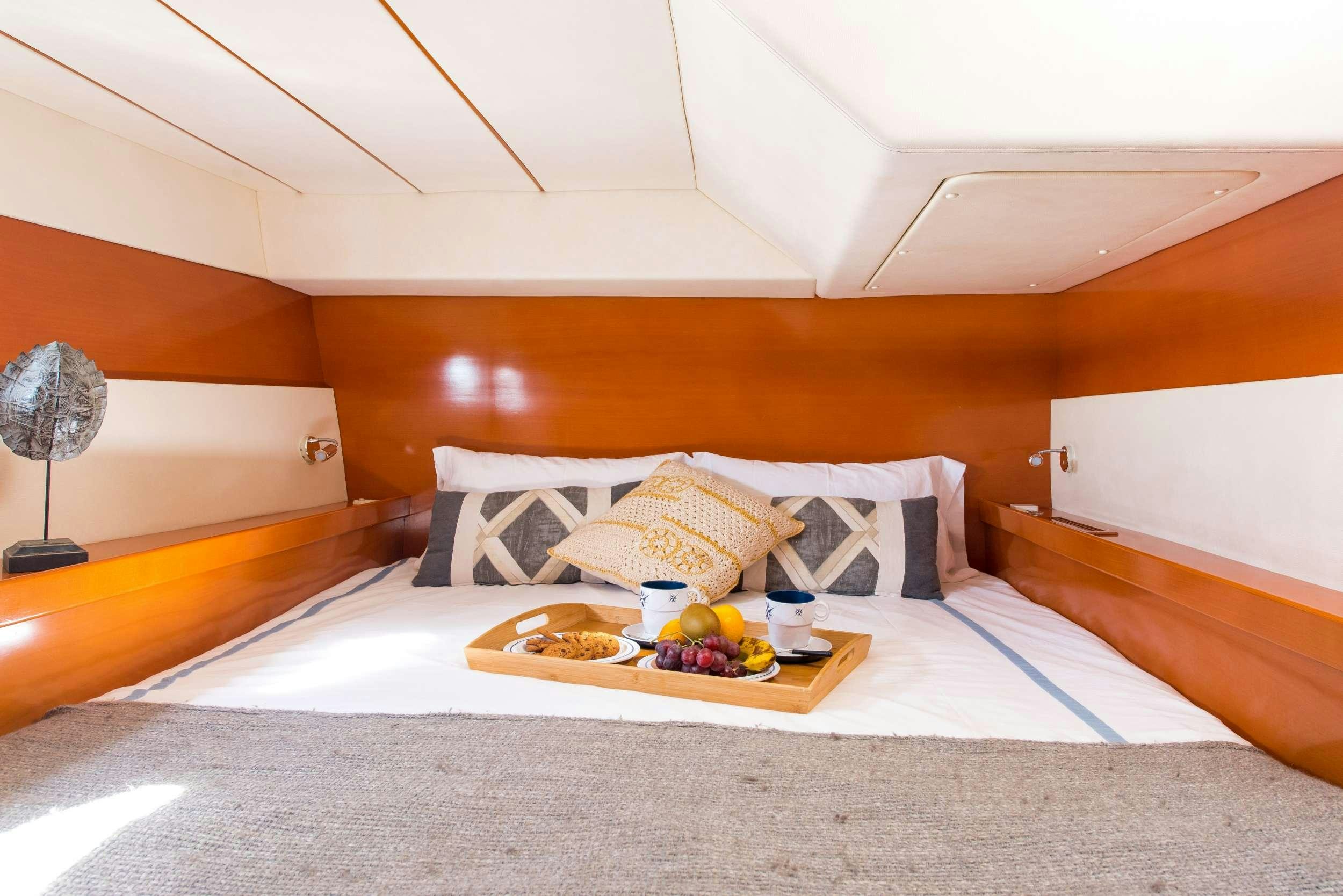 a bed with a tray of food aboard JOVA Yacht for Charter