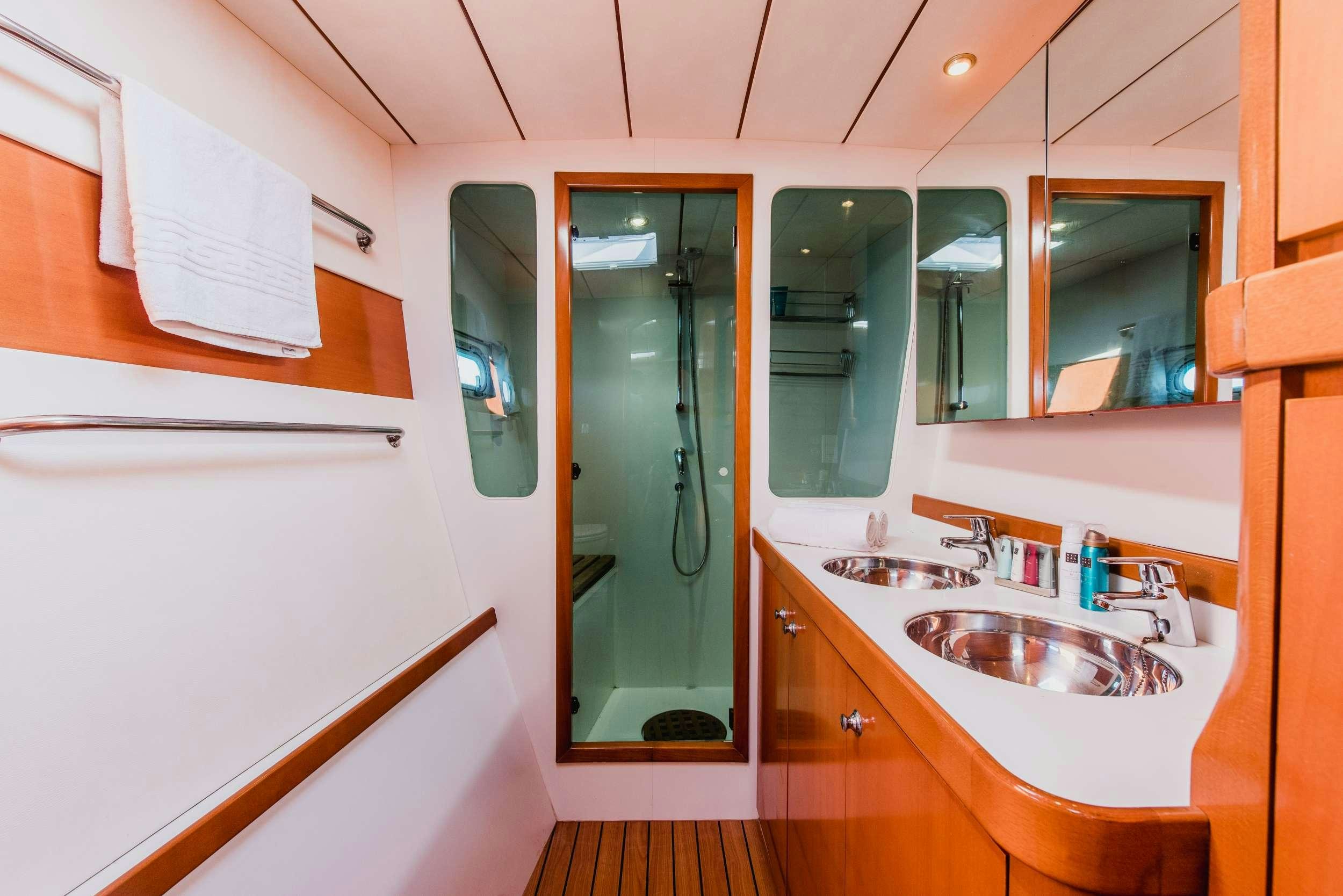 a bathroom with a sink and a mirror aboard JOVA Yacht for Charter