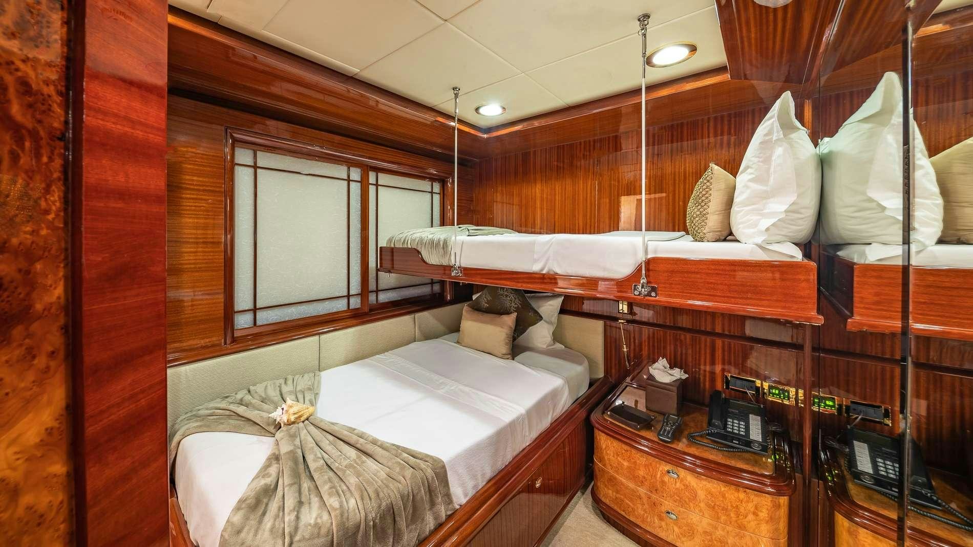 a bed with a white sheet and pillows aboard LADY LEILA Yacht for Charter