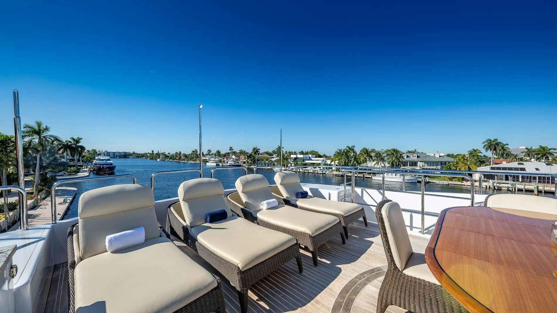 a deck with chairs and tables aboard LADY LEILA Yacht for Charter
