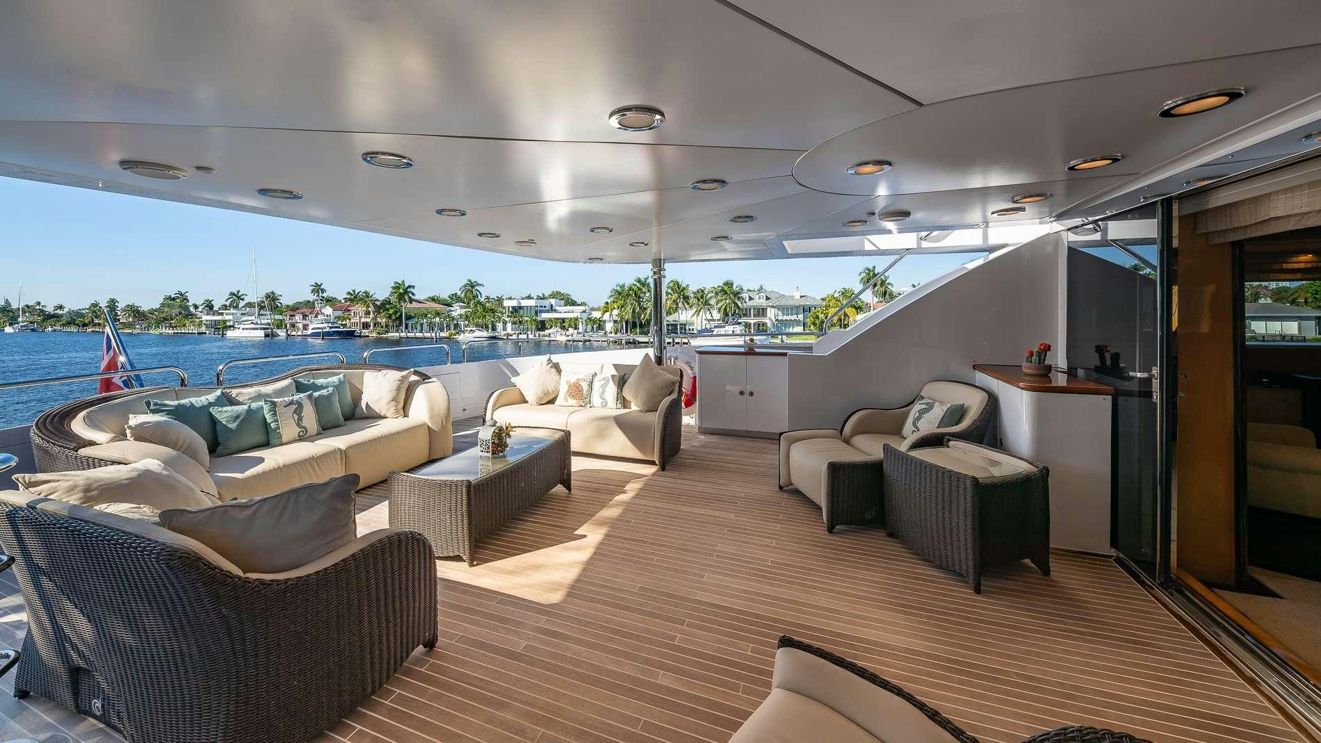 a room with a couch and a table and a pool aboard LADY LEILA Yacht for Charter