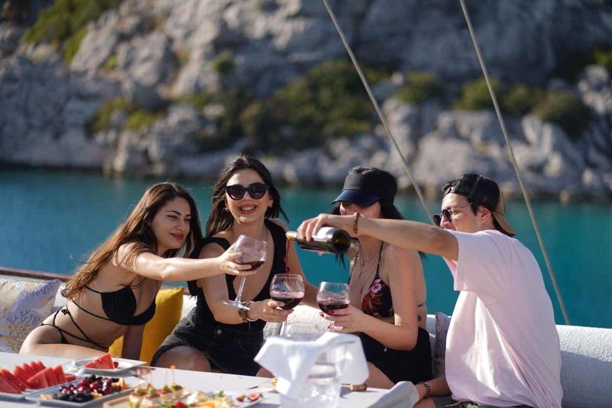 a group of women sitting on a boat with wine glasses aboard PRENSES ESILA Yacht for Charter