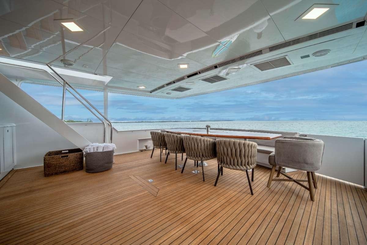 a room with a table and chairs aboard OCEAN DRIVE Yacht for Charter