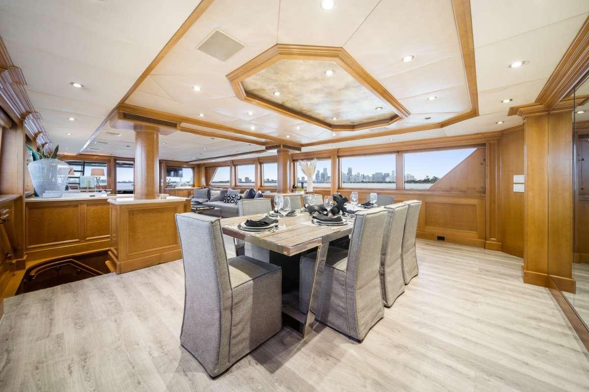 a large room with a table and chairs aboard OCEAN DRIVE Yacht for Charter