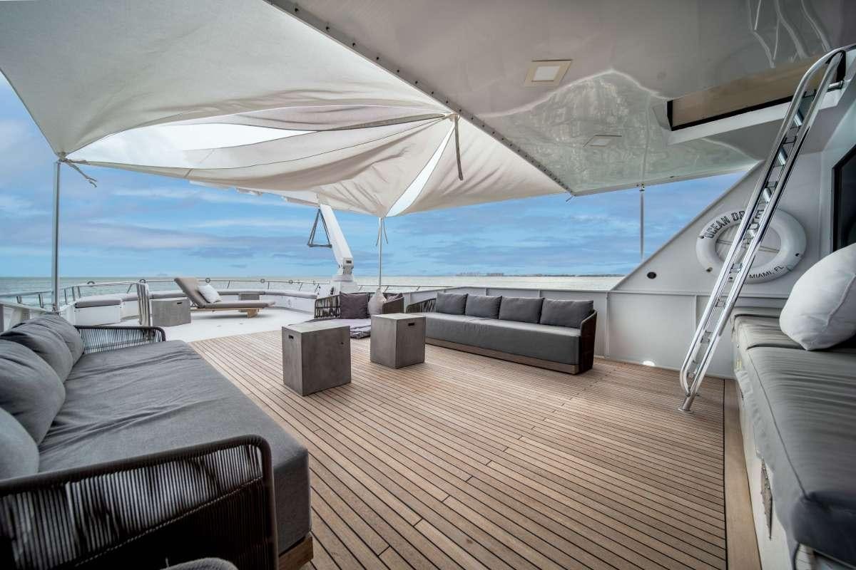 a tent with a bench and a couch aboard OCEAN DRIVE Yacht for Charter