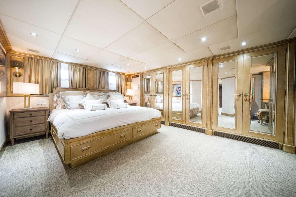 a large bedroom with a large bed aboard OCEAN DRIVE Yacht for Charter