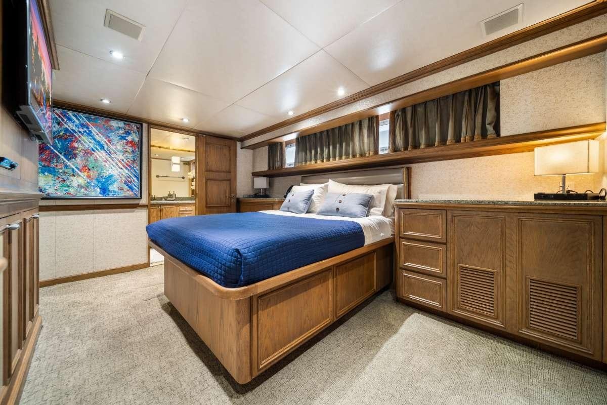 a bedroom with a bed and a tv aboard OCEAN DRIVE Yacht for Charter