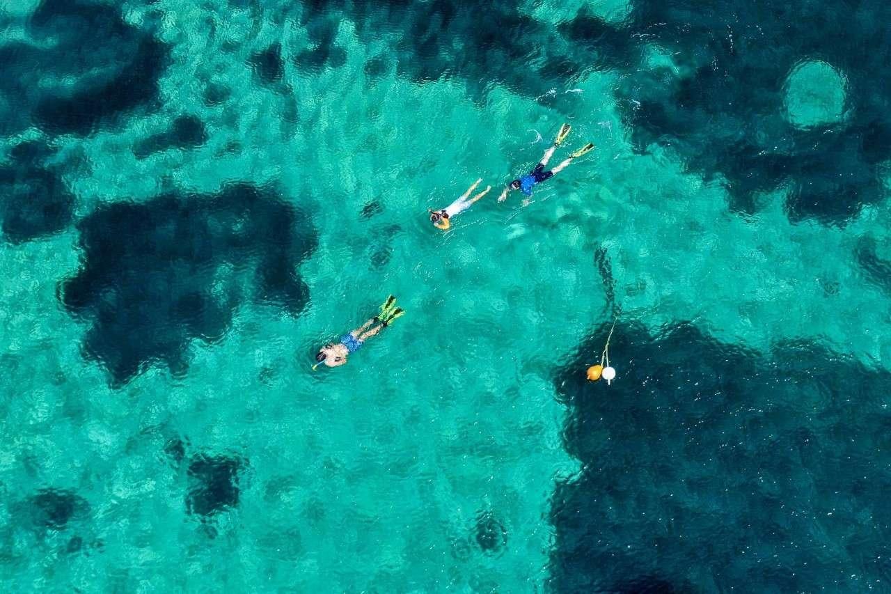 a group of people swimming in a body of water aboard MERIDIAN ADVENTURE Yacht for Charter