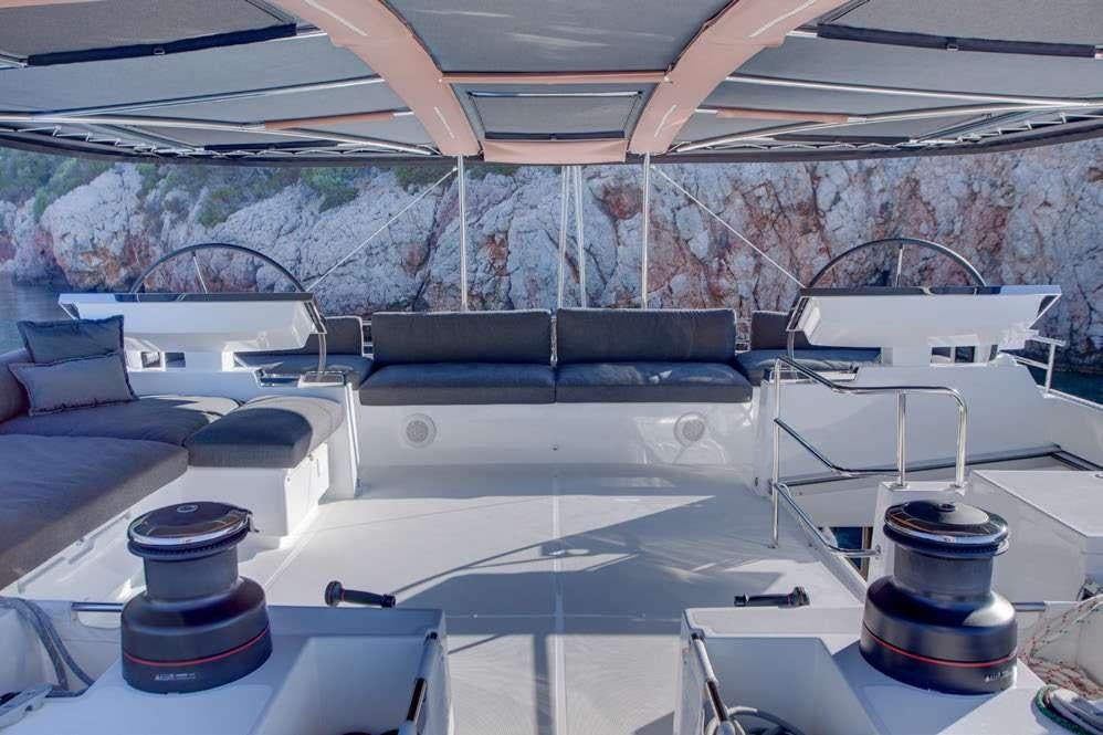 a room with a couch and a table with a lamp on it aboard MERIDIAN ADVENTURE Yacht for Charter