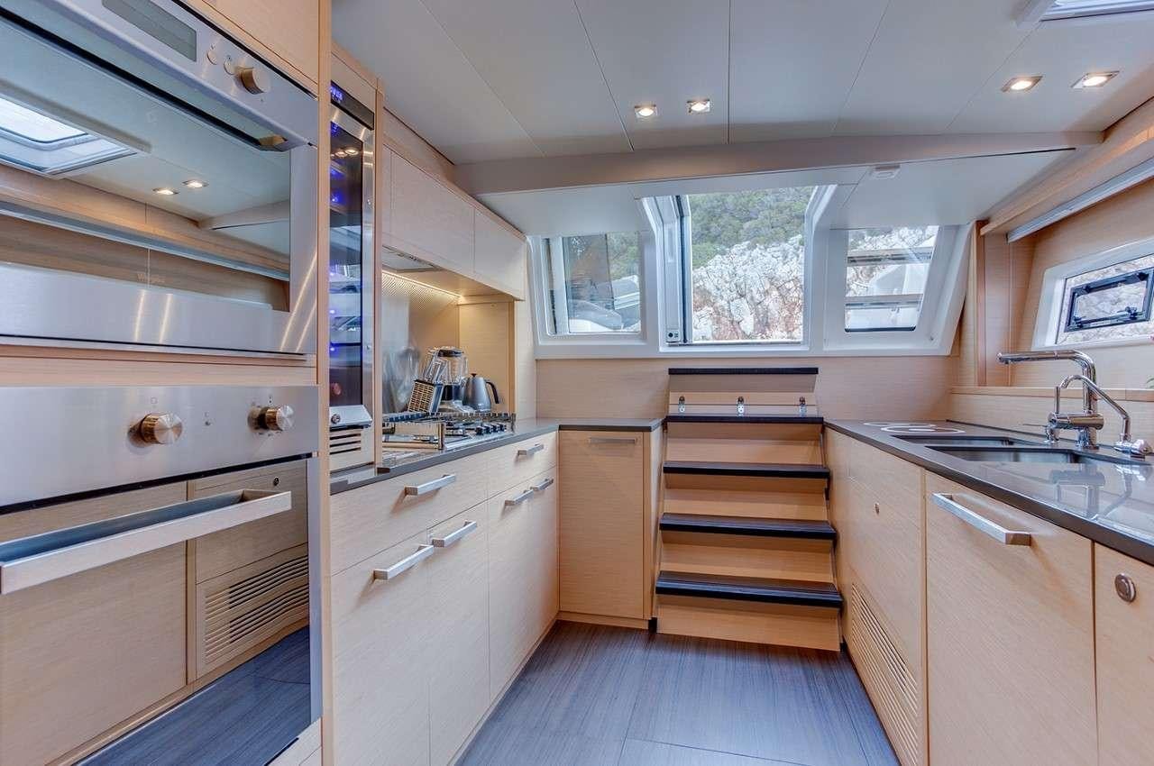 a kitchen with white cabinets aboard MERIDIAN ADVENTURE Yacht for Charter