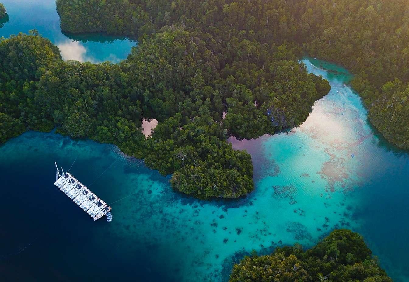 a boat in the water aboard MERIDIAN ADVENTURE - RAJA AMPAT Yacht for Charter
