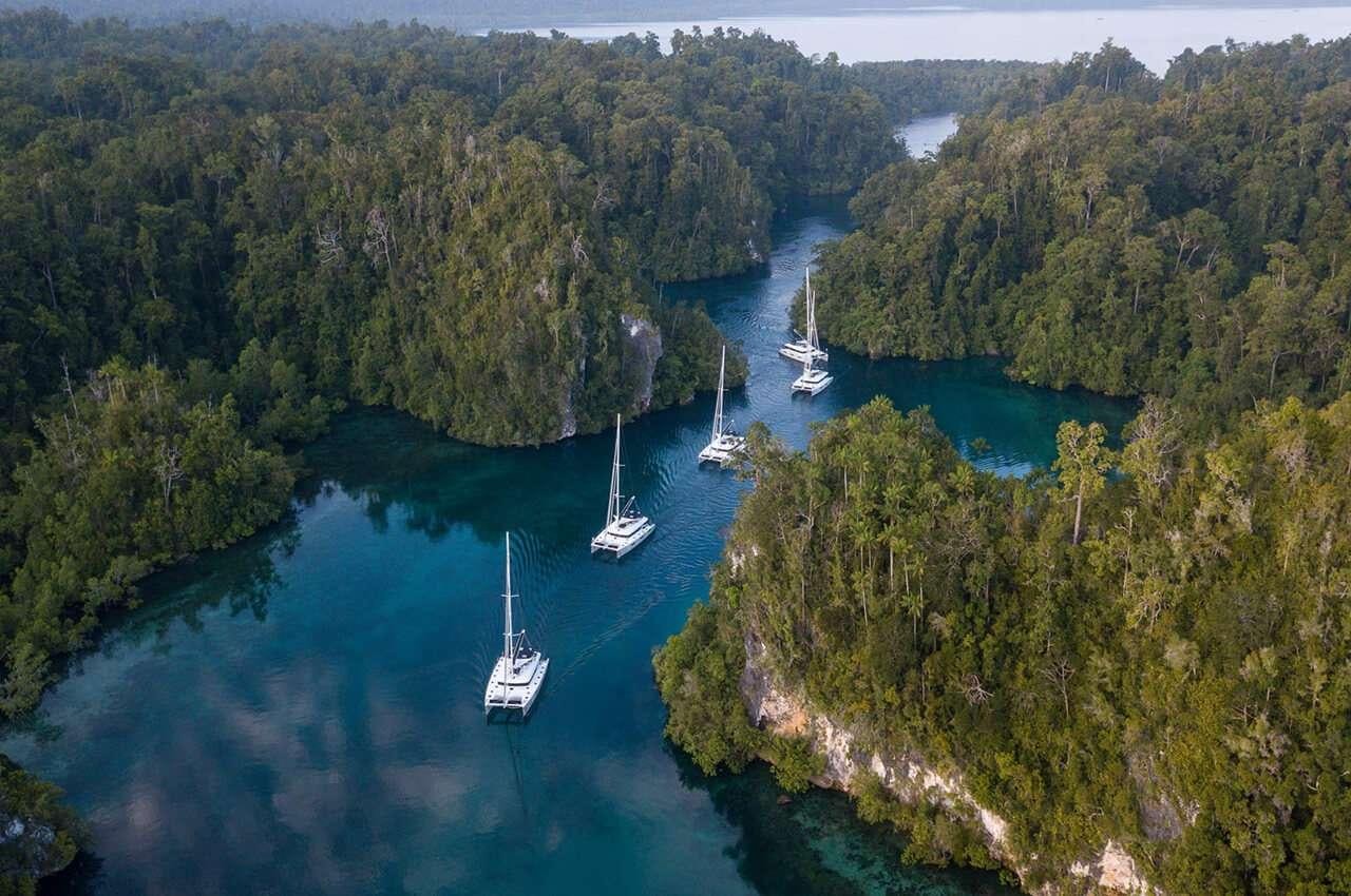 a group of boats in a river aboard MERIDIAN ADVENTURE - RAJA AMPAT Yacht for Charter