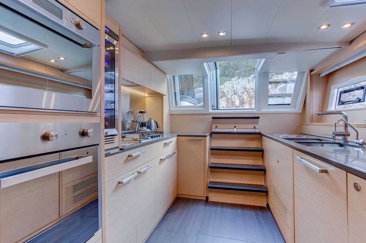 a kitchen with white cabinets aboard MERIDIAN ADVENTURE - RAJA AMPAT Yacht for Charter