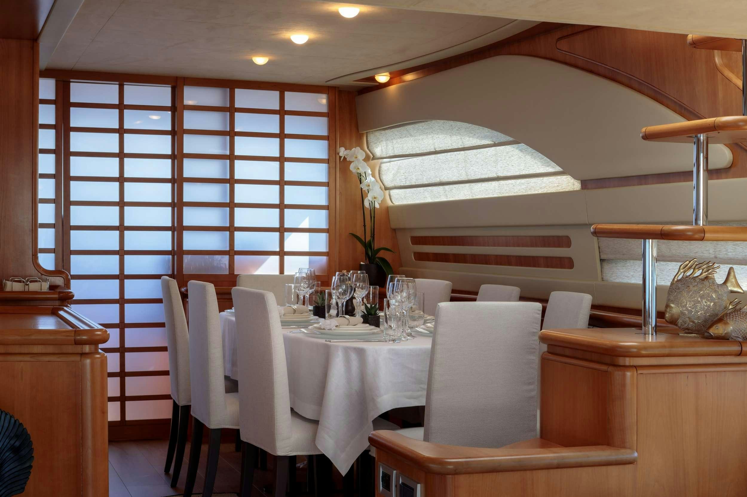 a room with tables and chairs aboard MY WAY Yacht for Charter
