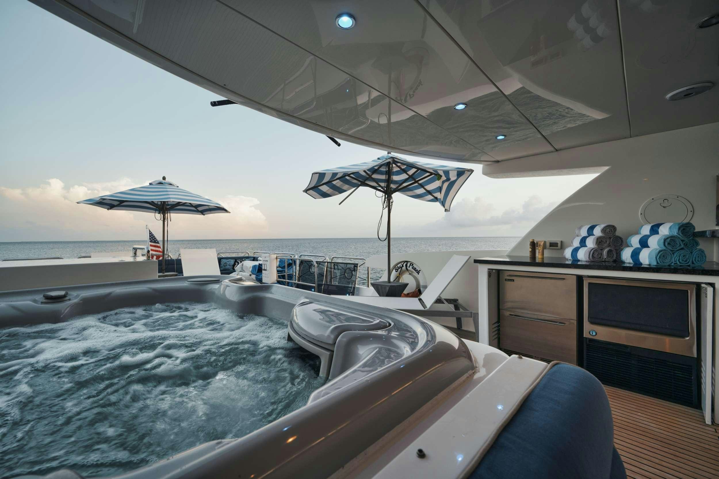 a large pool with a large umbrella aboard SHE'S A PEACH Yacht for Charter