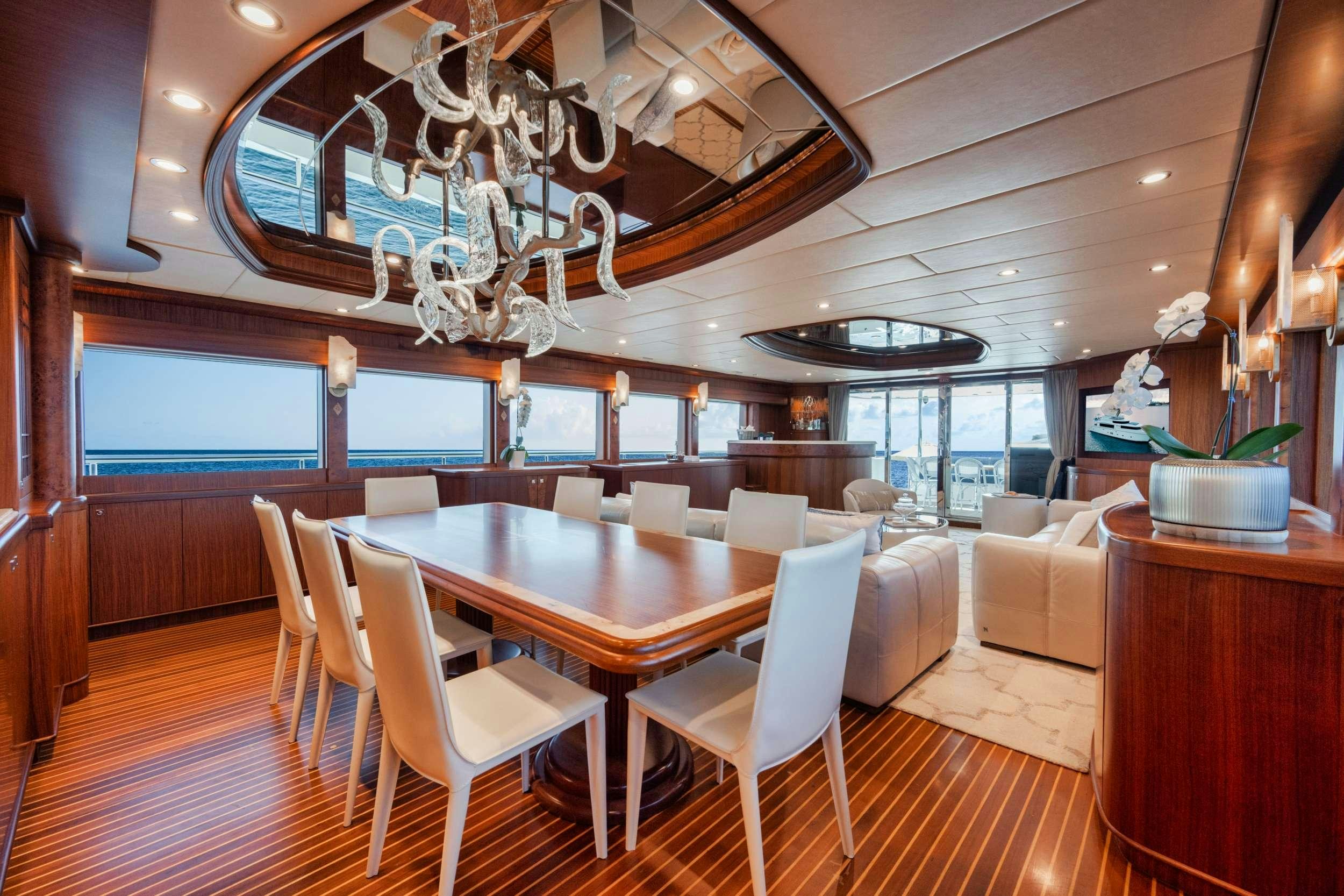 a large room with a table and chairs aboard SHE'S A PEACH Yacht for Charter