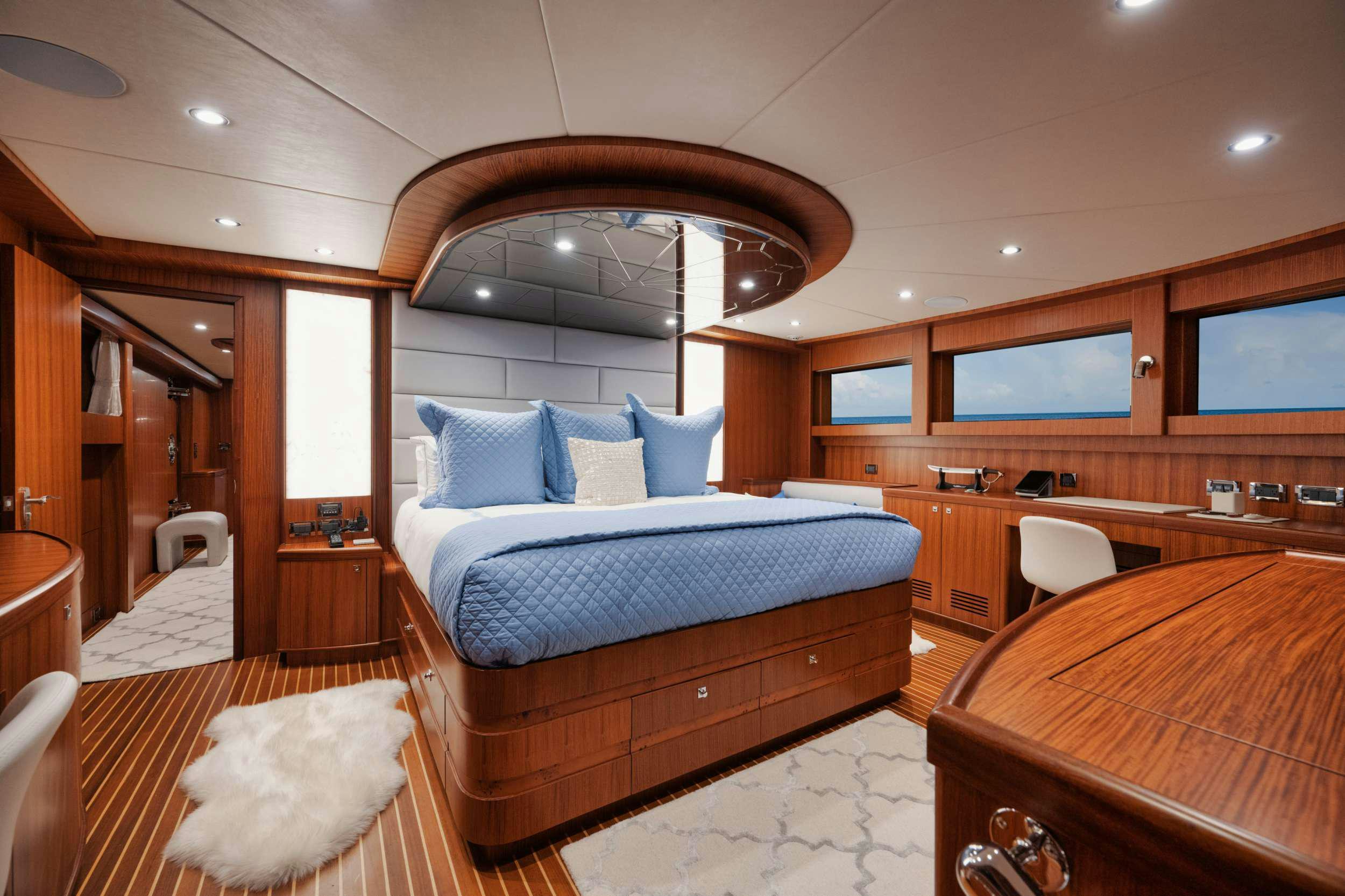 a room with a bed and a mirror aboard SHE'S A PEACH Yacht for Charter