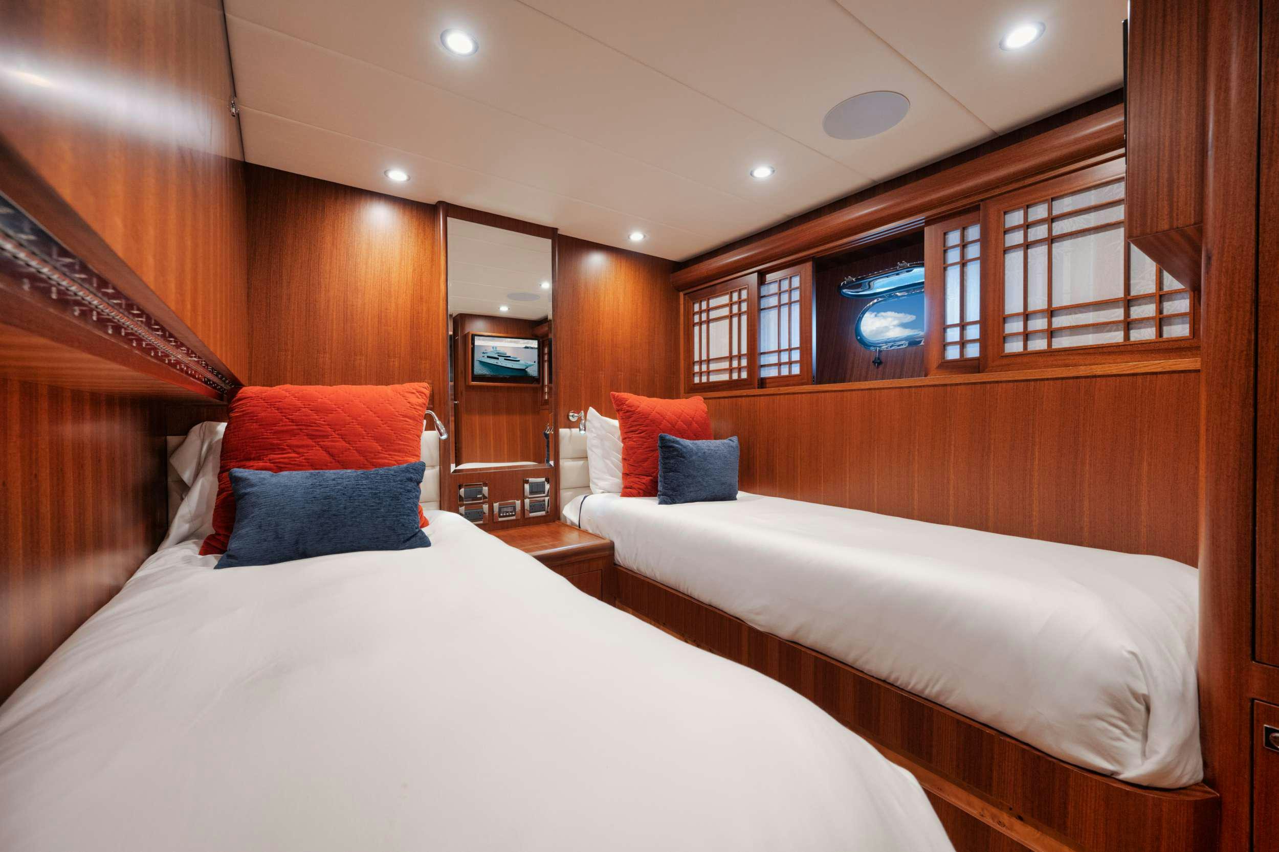 a room with a bed and a television aboard SHE'S A PEACH Yacht for Charter