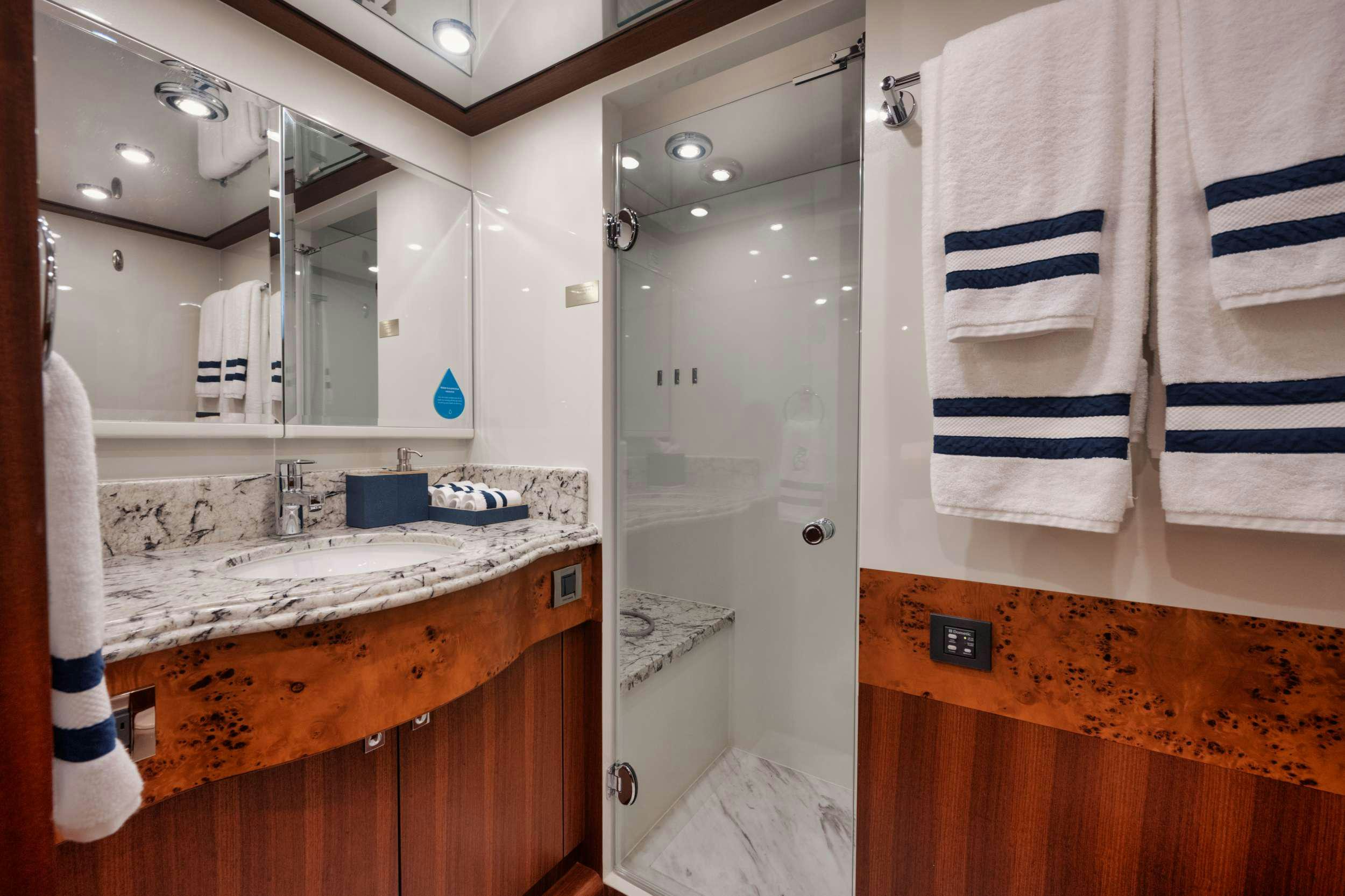 a bathroom with a sink and towels aboard SHE'S A PEACH Yacht for Charter