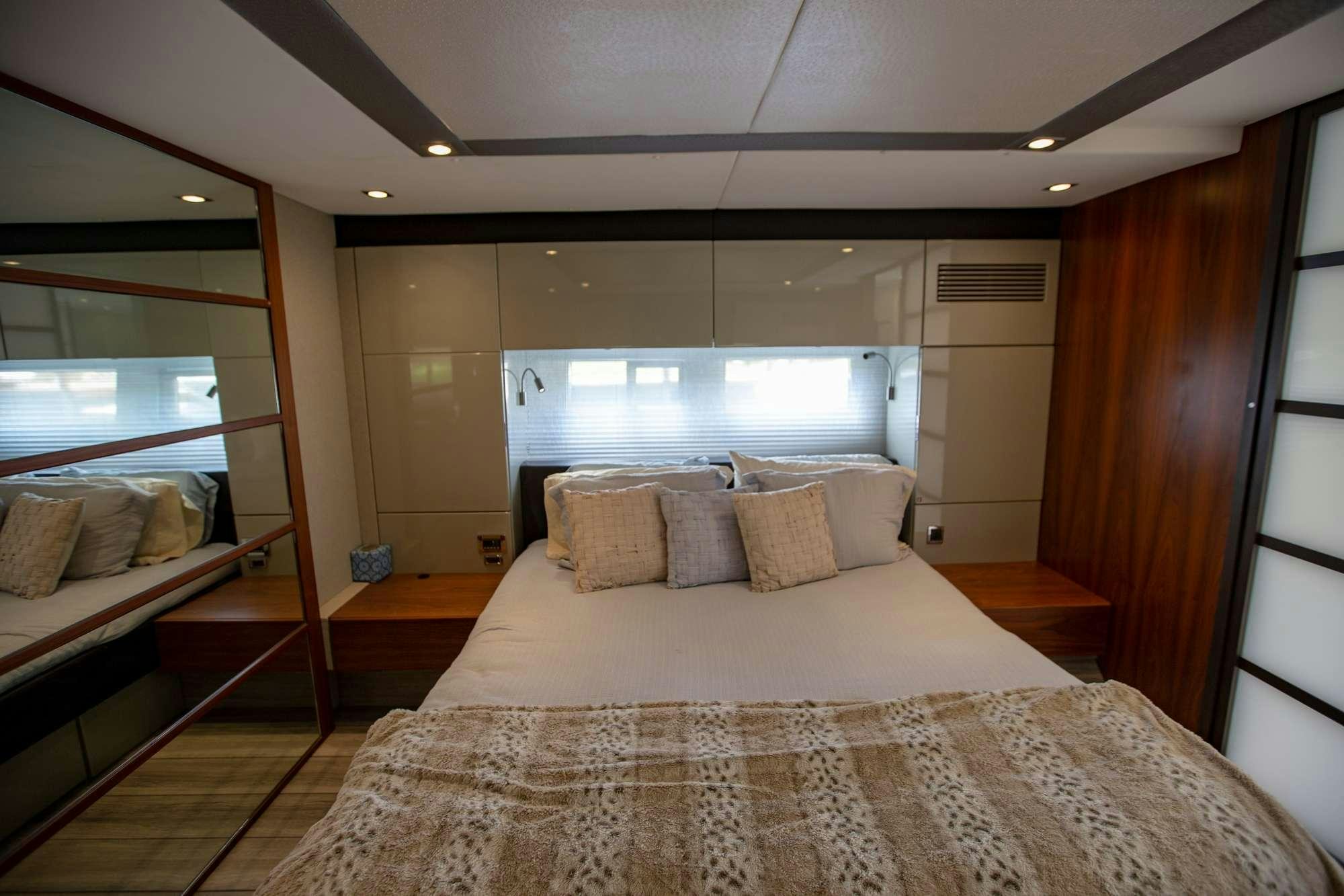 a bed with a large mirror above it aboard MY GIRL Yacht for Charter