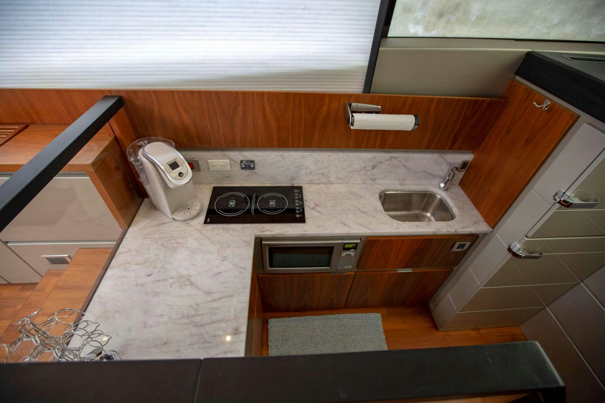 a kitchen with a sink and stove aboard MY GIRL Yacht for Charter